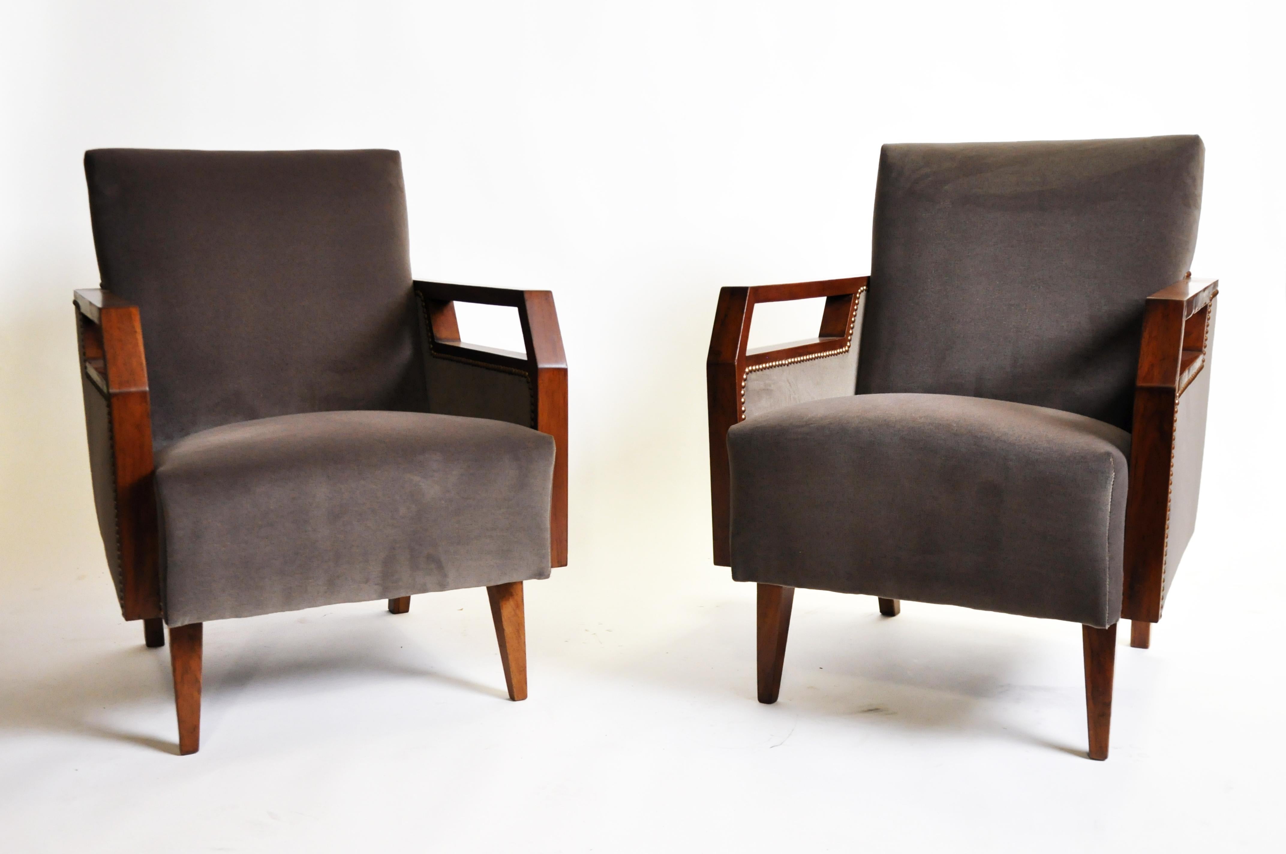 This handsome pair of Mid-Century Modern chairs are from France and made from walnut wood, circa 20th century. The chair has been reupholstered and arms have been touched up and restored as well. Strong and sturdy chairs.