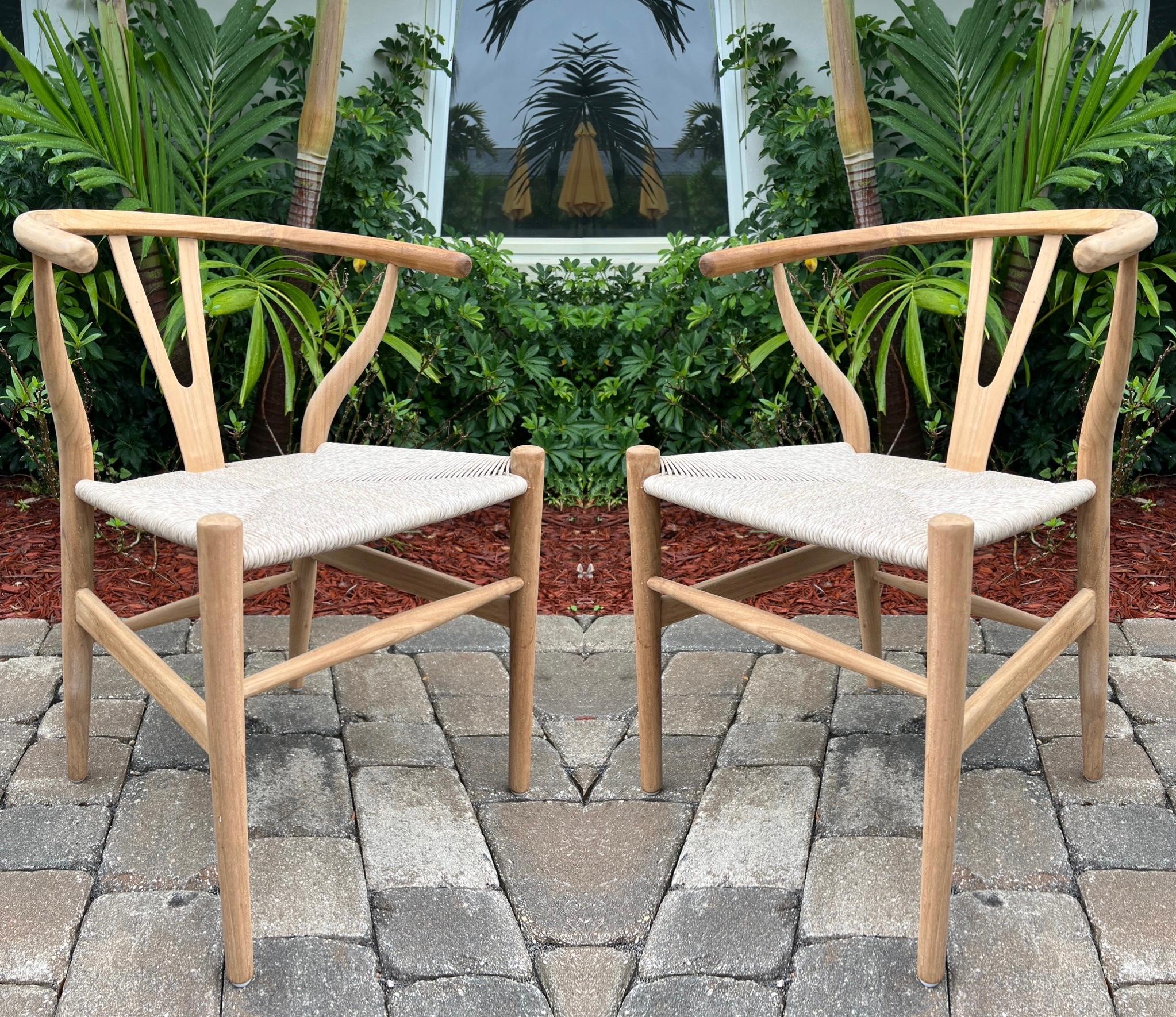 Danish Modern chairs in solid teak wood with a natural finish. Handcrafted curved frames feature a rounded top with Y-back design. The handwoven cord seats add to its organic beauty. Classic and timeless design makes these great accent chairs or a