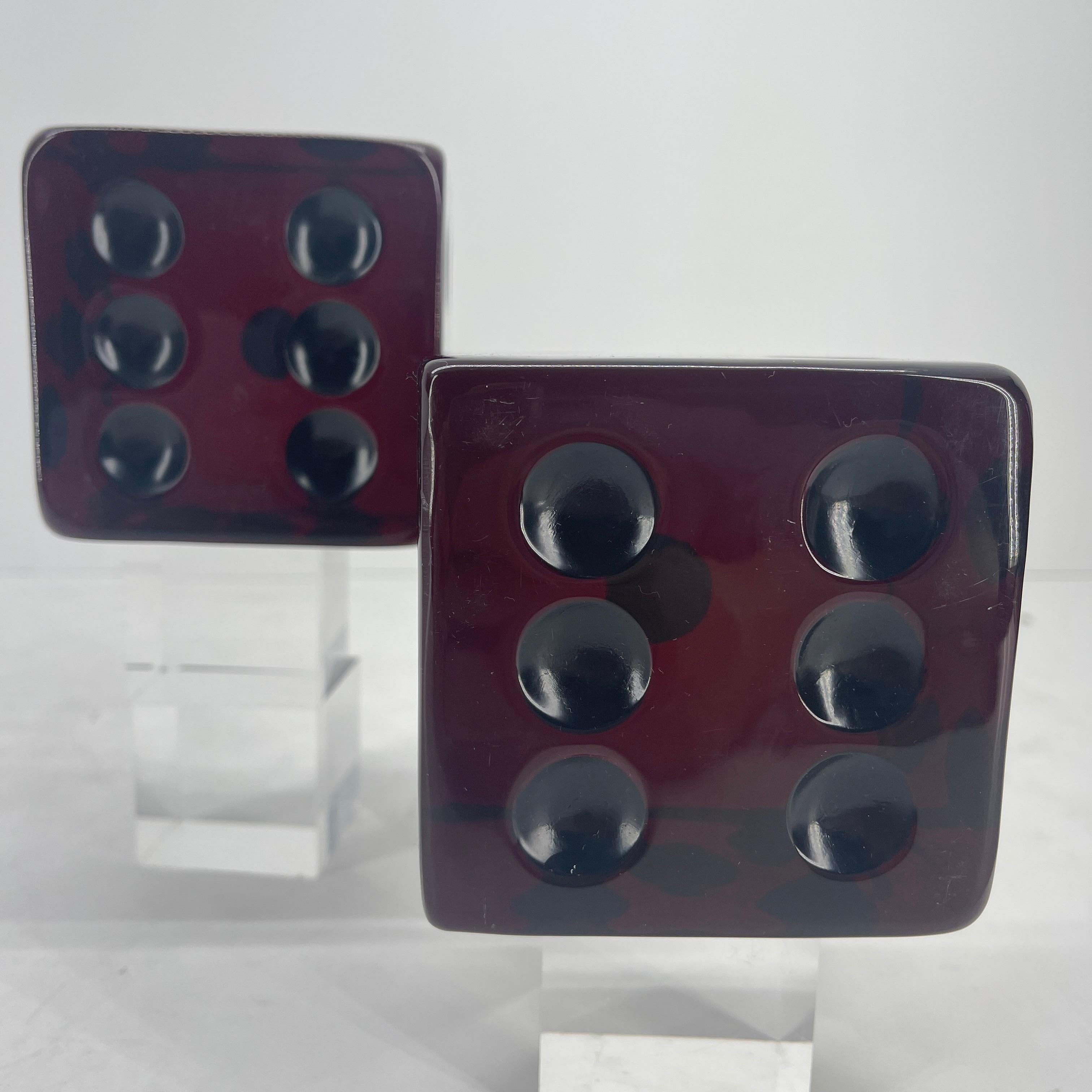 Feast your eyes on this glorious oxblood red pair of acrylic dice by Charles Hollis. These are spectacular when the light hits them, as they glow in burgundy tones. Perfect for accent pieces on a coffee table or as bookends. In very good vintage