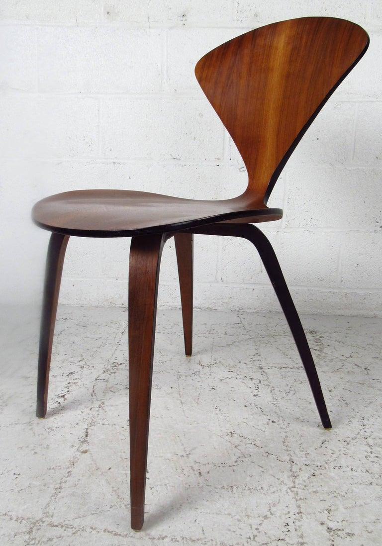 Pair of bent plywood chairs by Norman Cherner for Plycraft. An iconic design with a one of a kind shaped frame. A lovely wood grain, splayed legs, and elegant wood grain throughout shows quality.