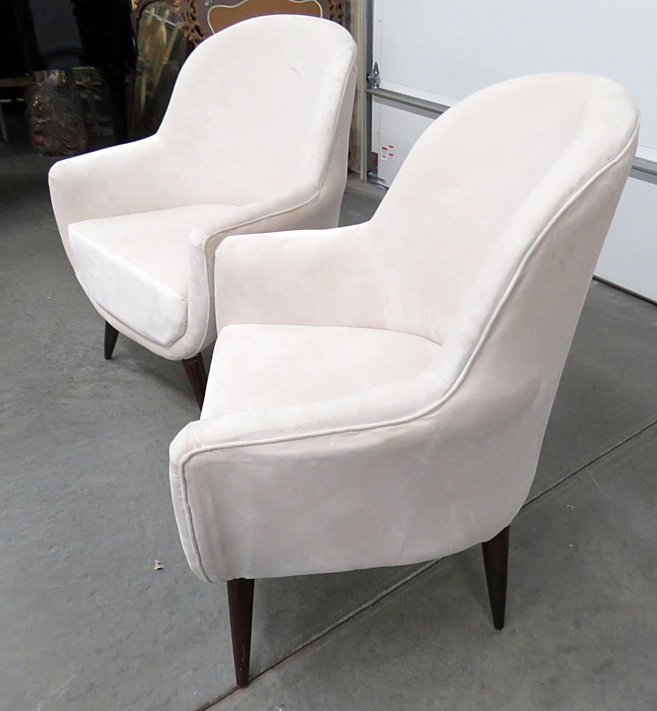 Pair of Mid-Century Modern upholstered club chairs with wooden legs.