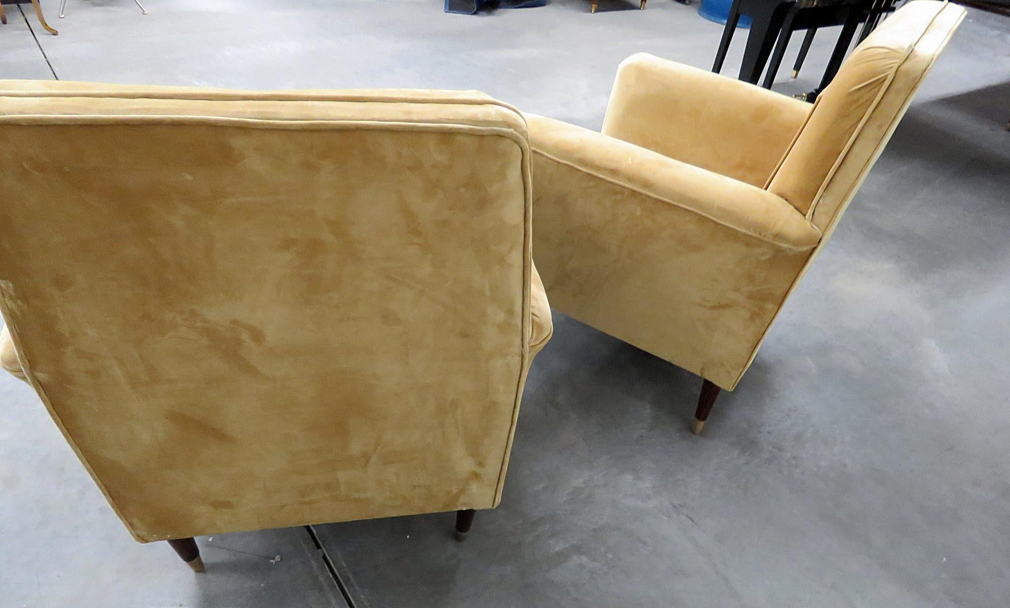 Pair of Mid-Century Modern velvet club chairs with brass sabots.