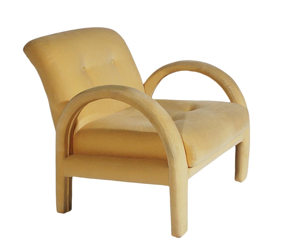 A unique set of arched arm lounge chairs in the style of Milo Baughman. These chairs feature interior wood construction with their original yellow velvet upholstery. Recovering is recommended due to age. Padding is great.