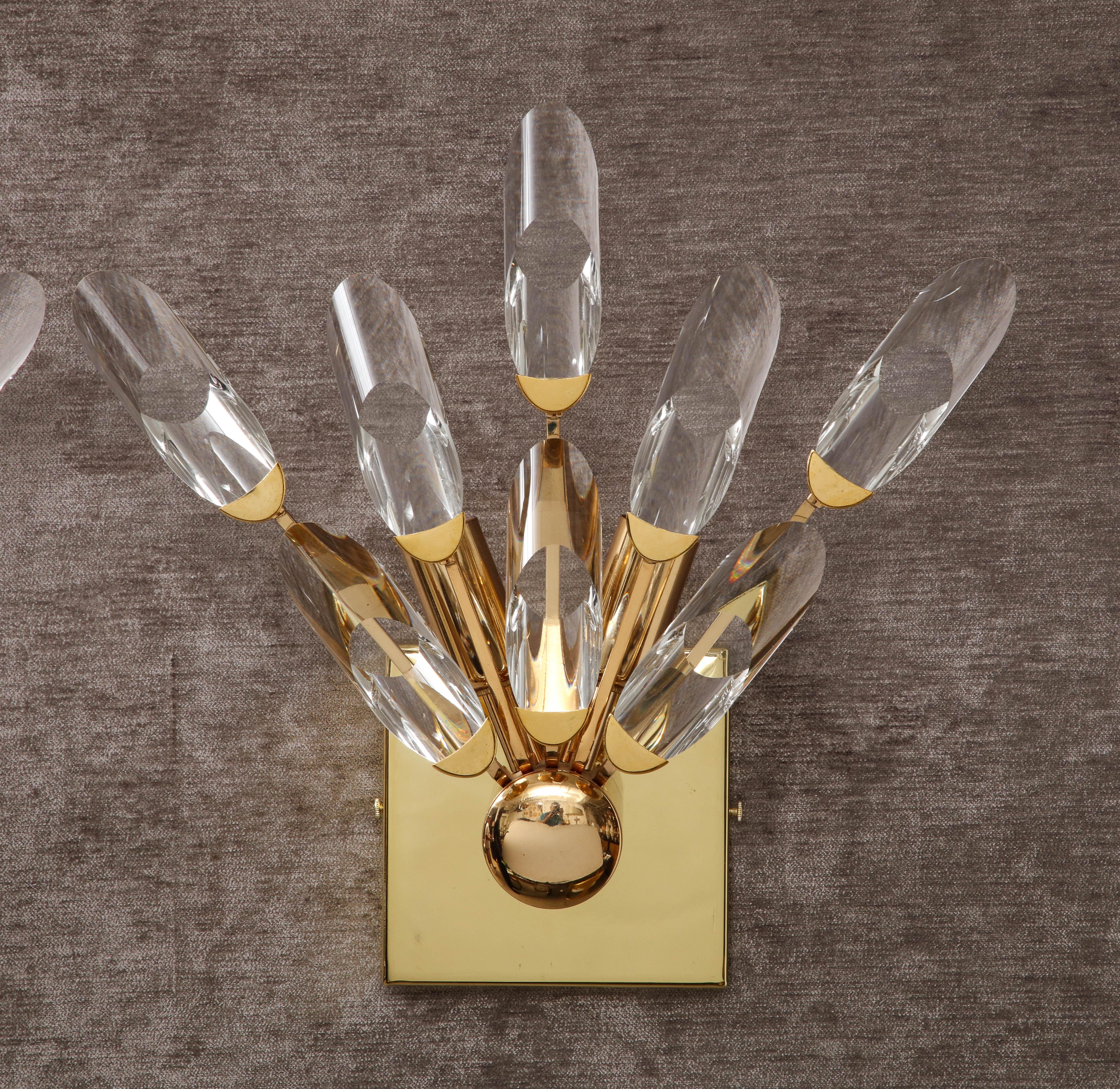 Beautiful pair of Crystal and Brass Sconces by Oscar Torlasco.
The polished brass fixture holds eight Crystal elements forming a half sunburst pattern which gives a wonderful light when illuminated.
It has been Newly rewired with two Candelabra