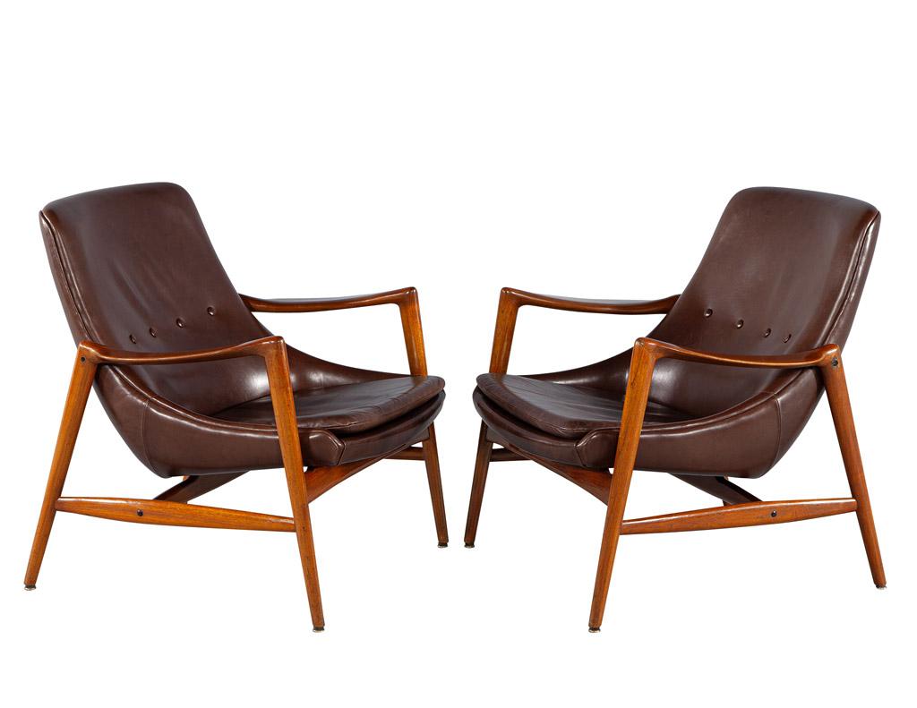 These mid-century modern Danish Leather lounge chairs are a stunning combination of classic Danish design and modern styling. Crafted from the finest teak woods and leather, these chairs were made in Denmark, circa 1960’s. The curved seats offer a