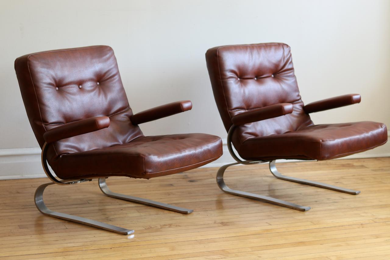 Two matching Mid-Century Modern cantilever chrome chairs circa 1970s.
Chrome base curved to give a spring or slight rock when you sit.
Tufted brown leather in fantastic shape with just the right amount of patina.
These are extremely comfortable,