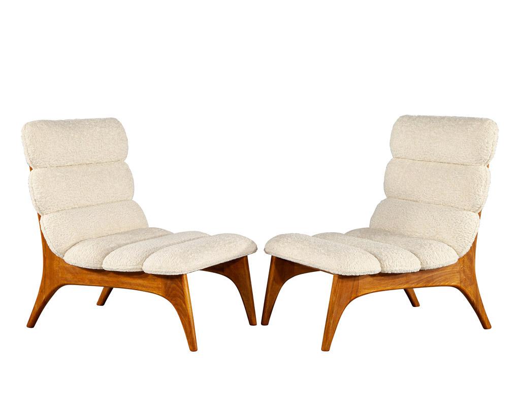 This pair of mid-century modern lounge chairs is an iconic piece of Danish styling that has been crafted with a curved design, composed of teak wood, and upholstered with a boucle fabric. Made in Denmark during the 1970's, these chairs feature a
