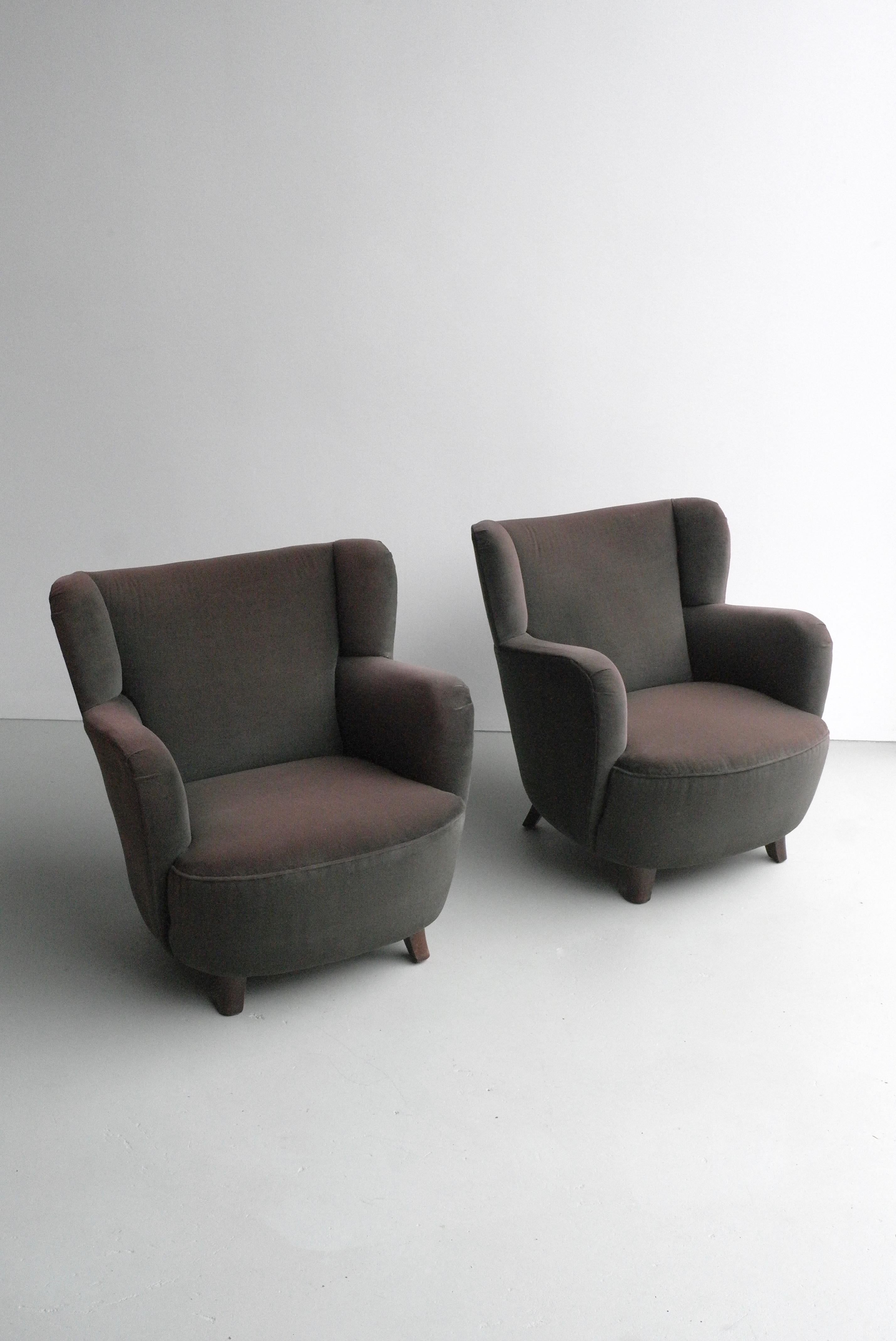 Pair of mid-century Danish club chairs in brown velvet with eggplant glow.