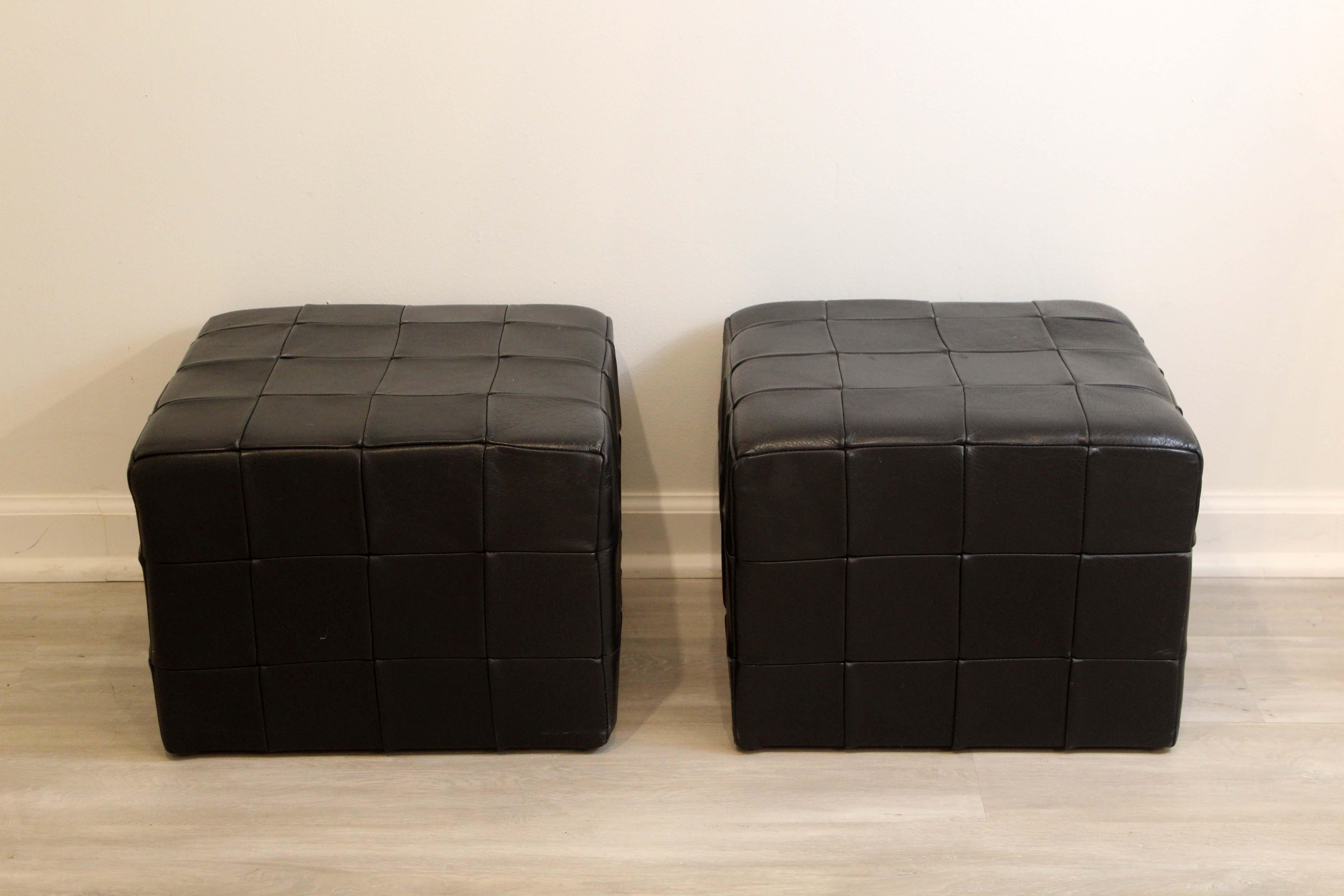 We present a pair of vinatge leather patchwork leather ottomans by Desede. In good vintage condition. Dimensions: 16.5