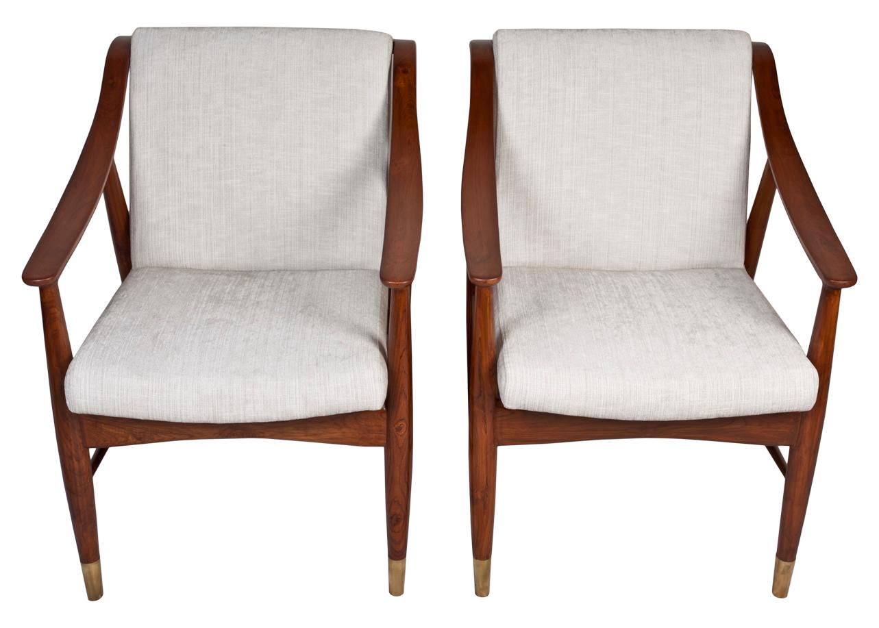 A pair of Danish teak side chairs in the style of Louis Van Teeffelen, Mid-Century Modern. Reupholstered with an off-white silk and linen blend. Brass feet.