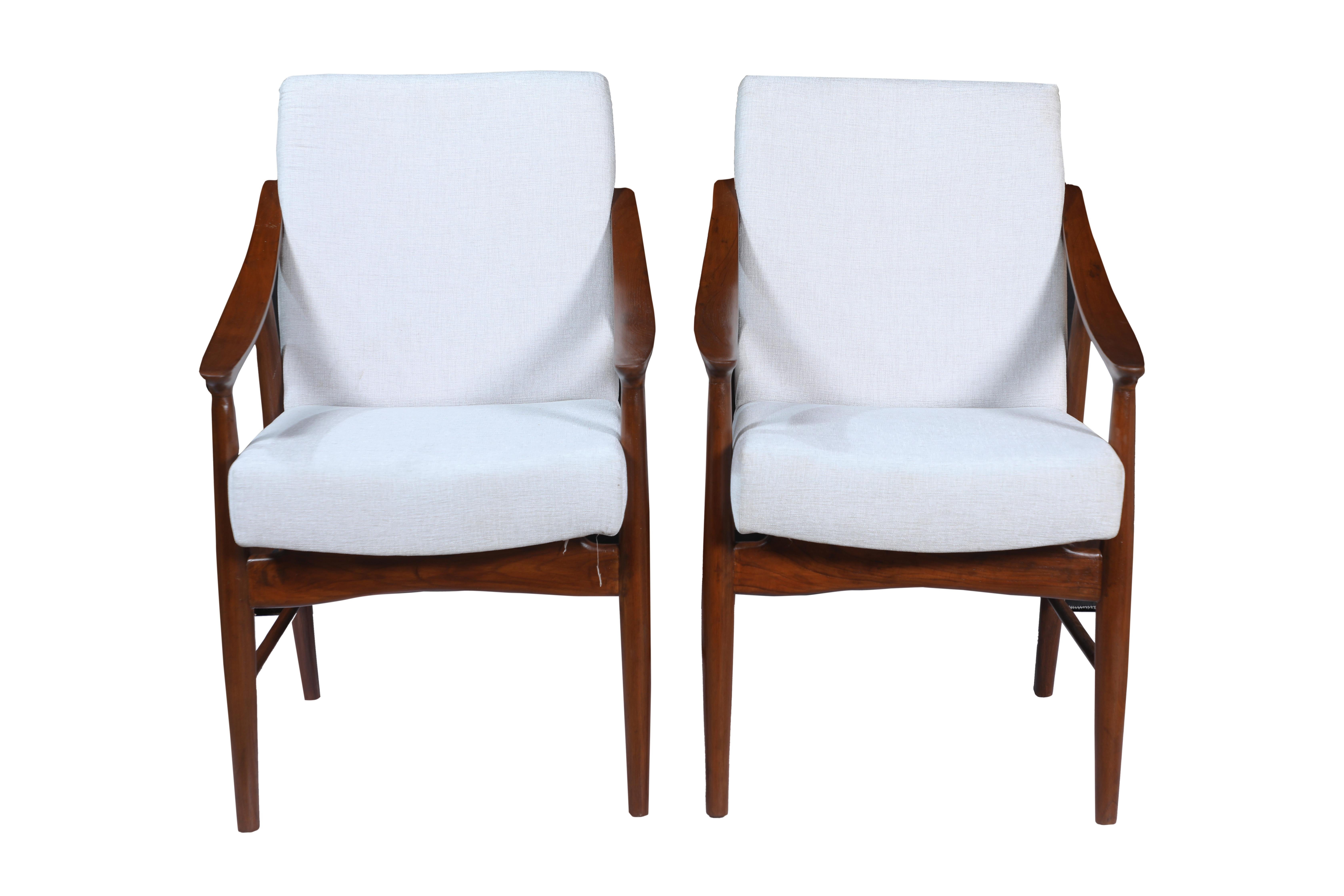 A handsome pair of Danish teak Mid-Century Modern side armchairs. Great to use in an office or in a living room or sitting room. A lovely sweep the the arms make them quite comfortable. They have been refinished and reupholstered in a linen/silk