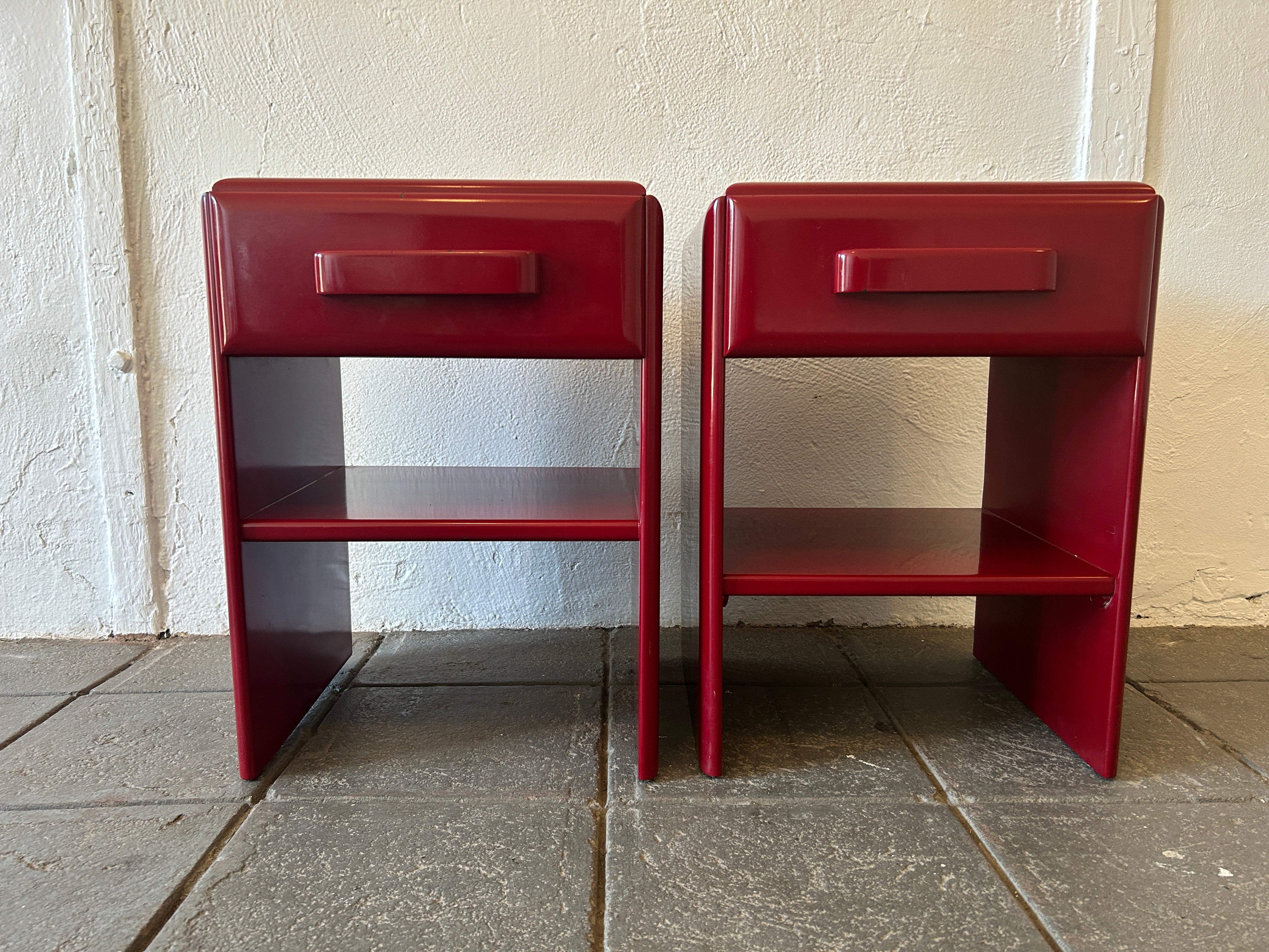 Pair of Mid-Century Modern design Russel Wright Dark Red lacquer Single drawer nightstands. Made from solid maple. Designed by the famous architect Russel Wright. In original condition showing normal wear from use. Labeled inside drawers. One lower