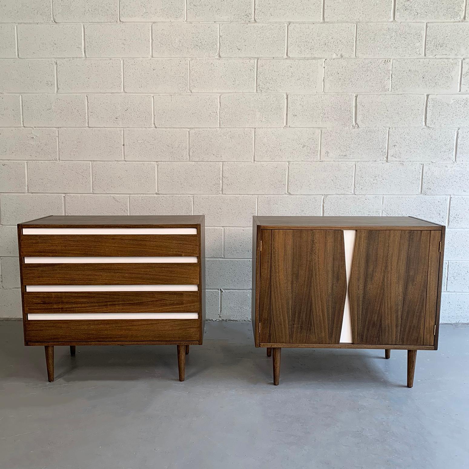 Pair of complimentary, Mid-Century Modern, dresser cabinets by American of Martinsville are walnut with white laminate accents. One cabinet is a dresser that features 4 drawers and the other is a short credenza configuration with interior shelves.