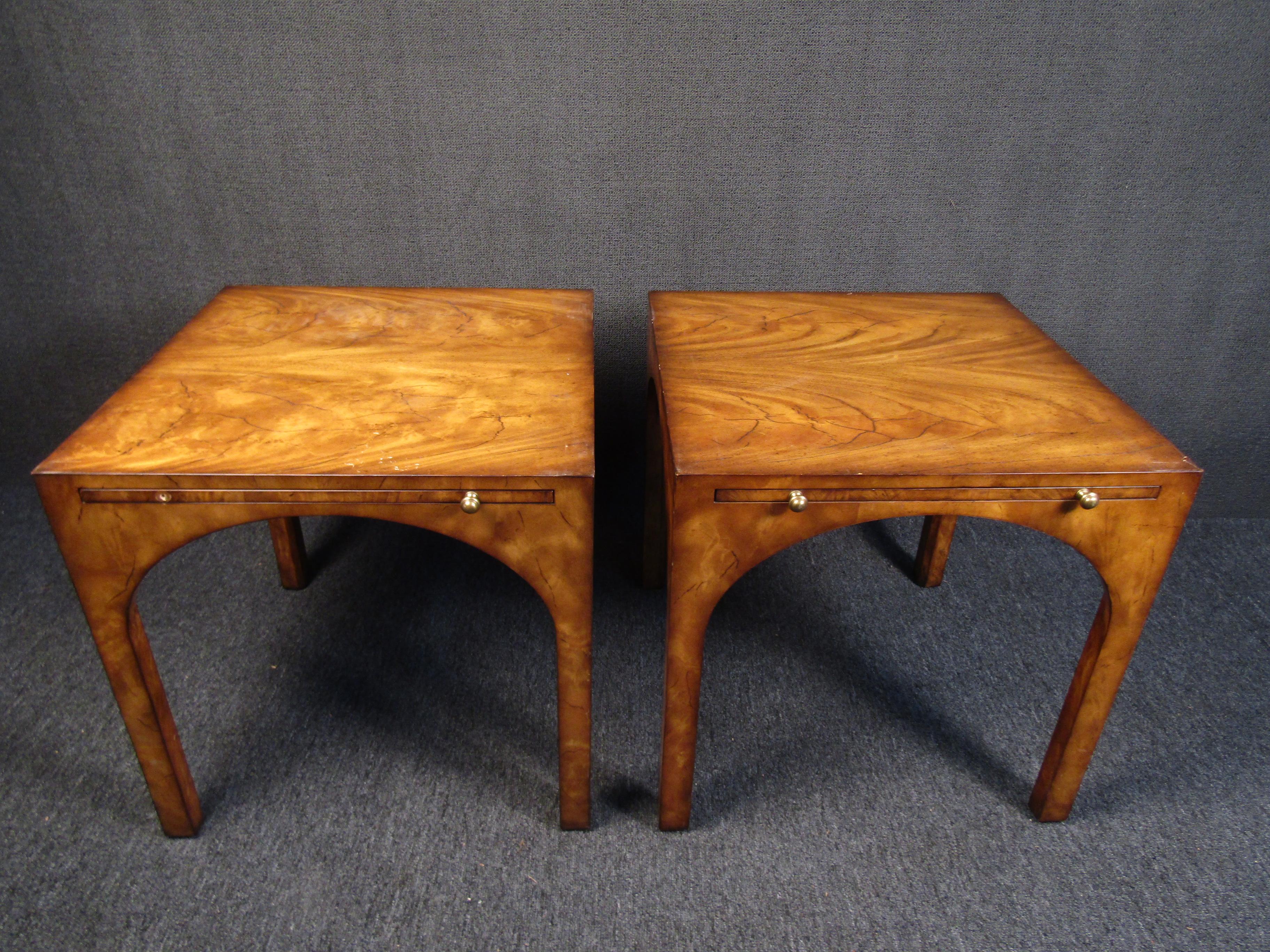 This unique pair of end tables, made by Baker Furniture Co. in the USA, are just as well-built as they are elegant and full of character. Trays extend from each table with brass pulls on the end of the tray. Please confirm item location with seller