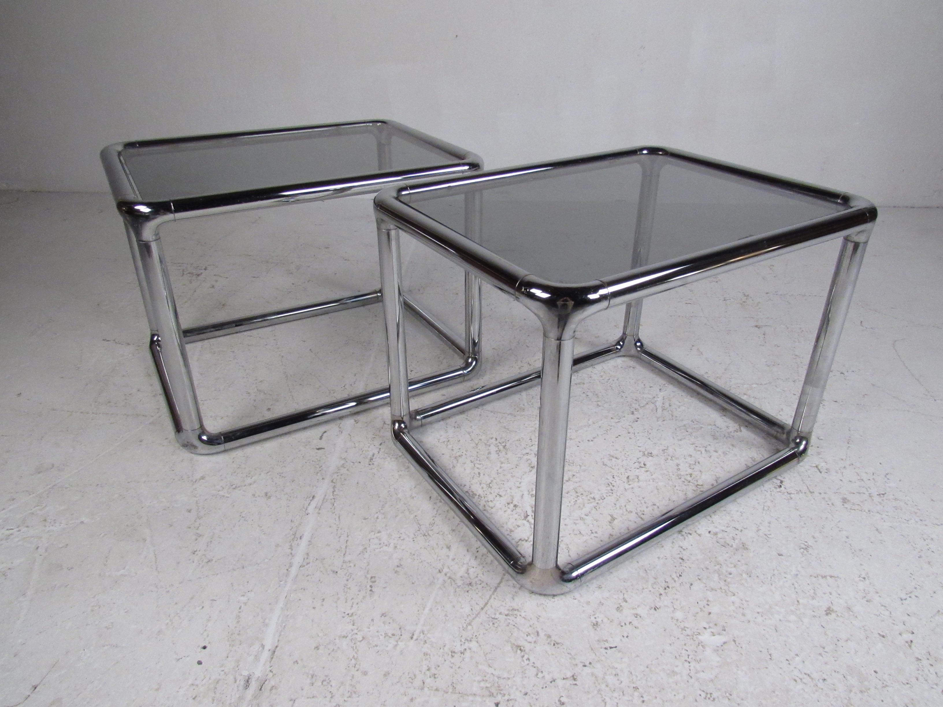 This beautiful pair of vintage modern end tables feature a unique chrome rod frame. Sleek and sturdy design with a gray tinted-glass tabletop. This unusual mid-century pair makes the perfect addition to any modern interior. Please confirm item