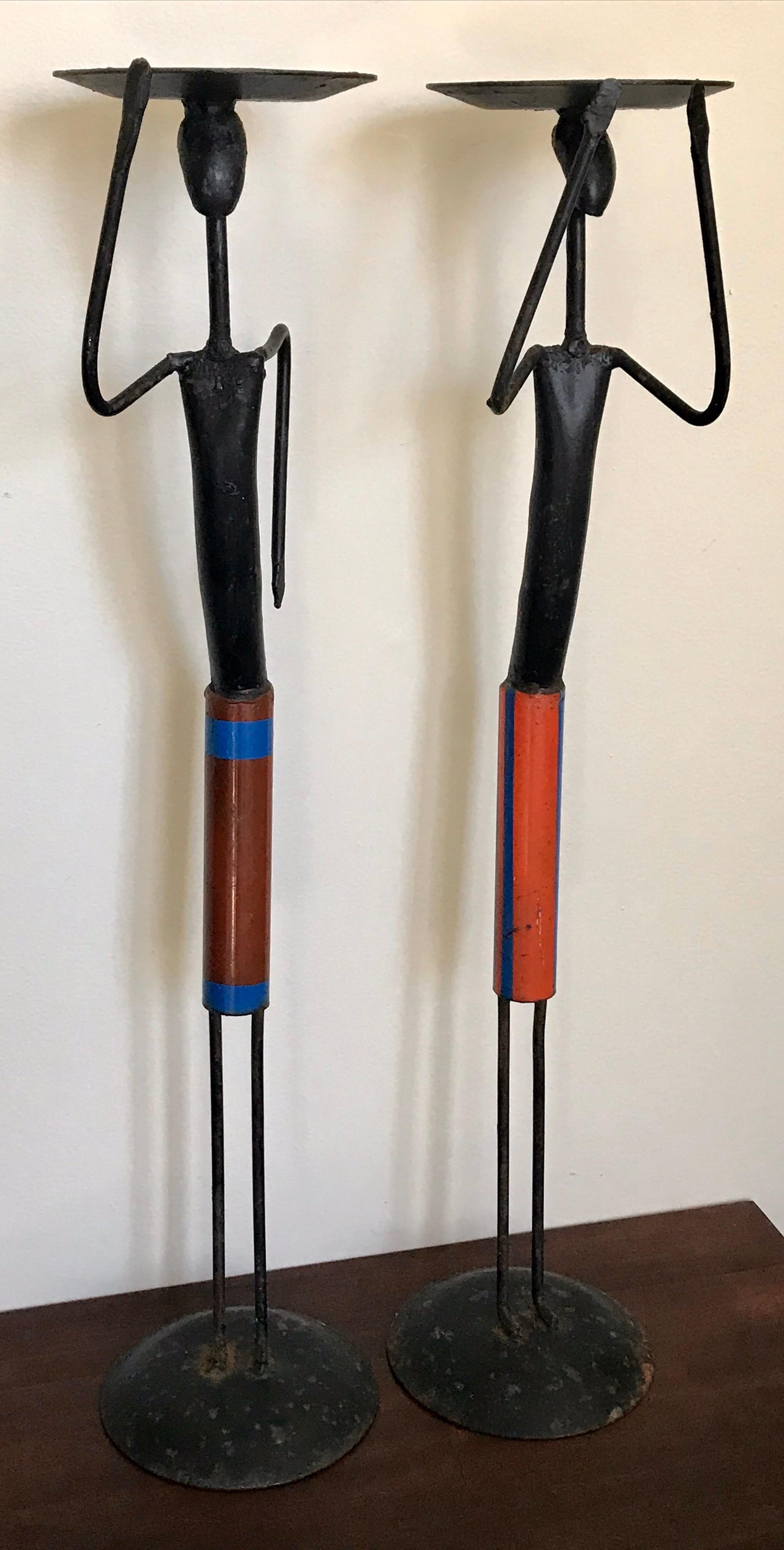 Cool pair of midcentury wrought iron candleholders, figurative African women, 1960s.