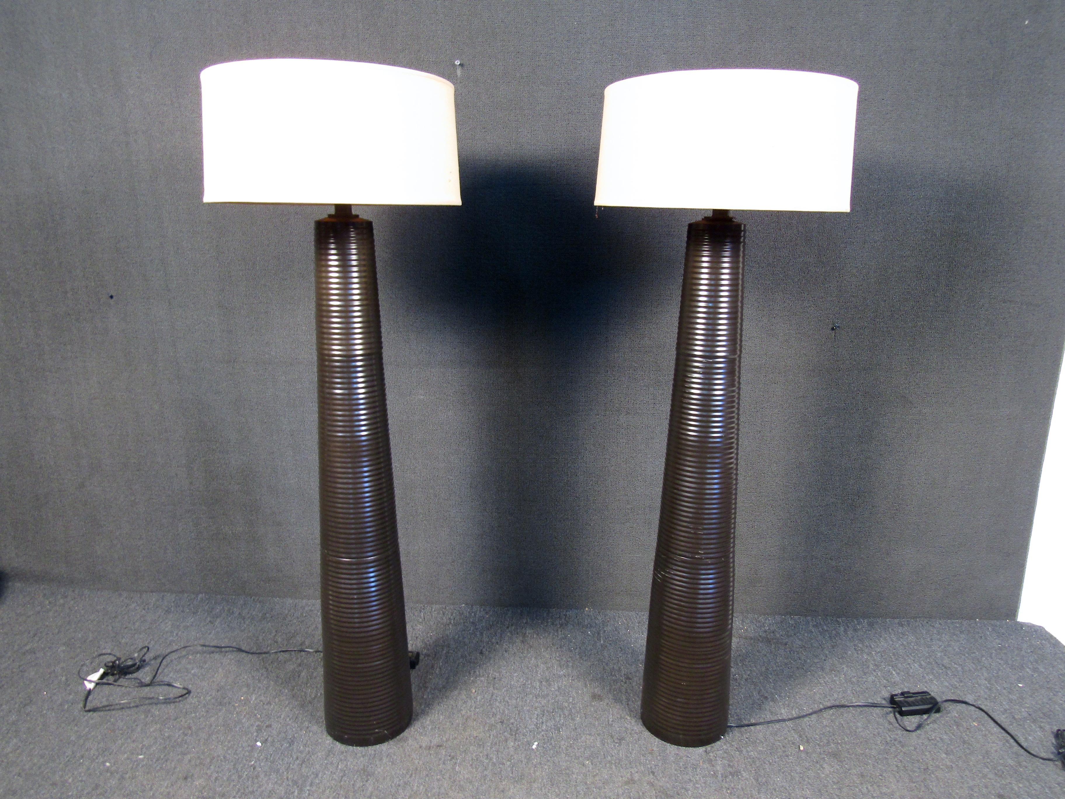 This pair of vintage Mid-Century Modern lamps features matching shades and Stand high at 64 inches. These lamps will make a great addition to any home or office space.
Please confirm item location (NJ or NY).