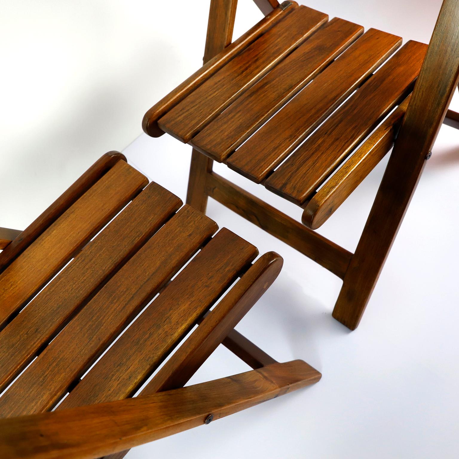 Circa 1960. We offer this pair of Mid-Century Modern folding chairs in exotic tropical wood.