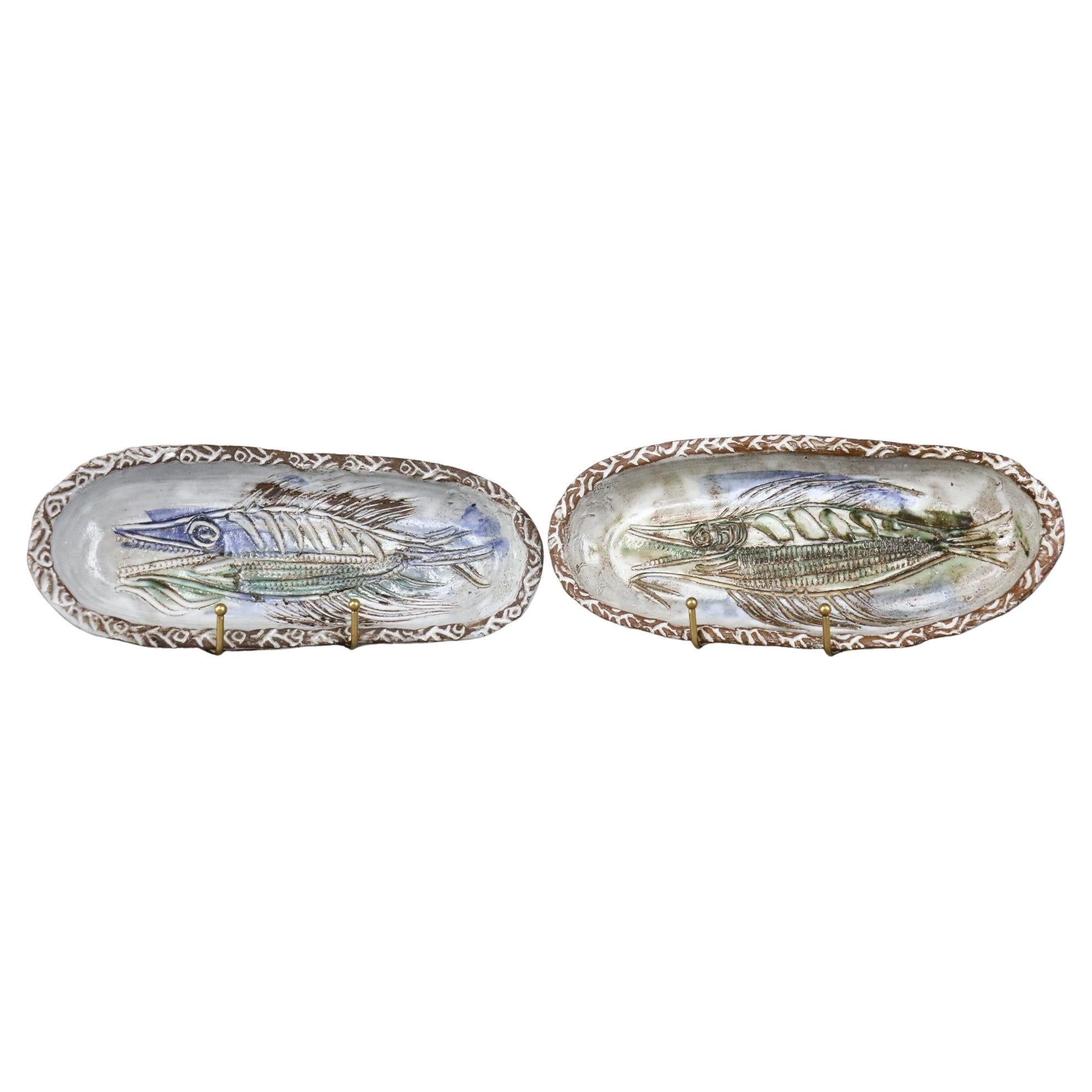 Pair of Mid-Century Modern French Ceramic decorative trays Albert Thiry, 1960s

Very nice set of two decorative ceramic trays decorated with fish. The chalk white enamel is of very good quality. It brings out the motifs engraved by the