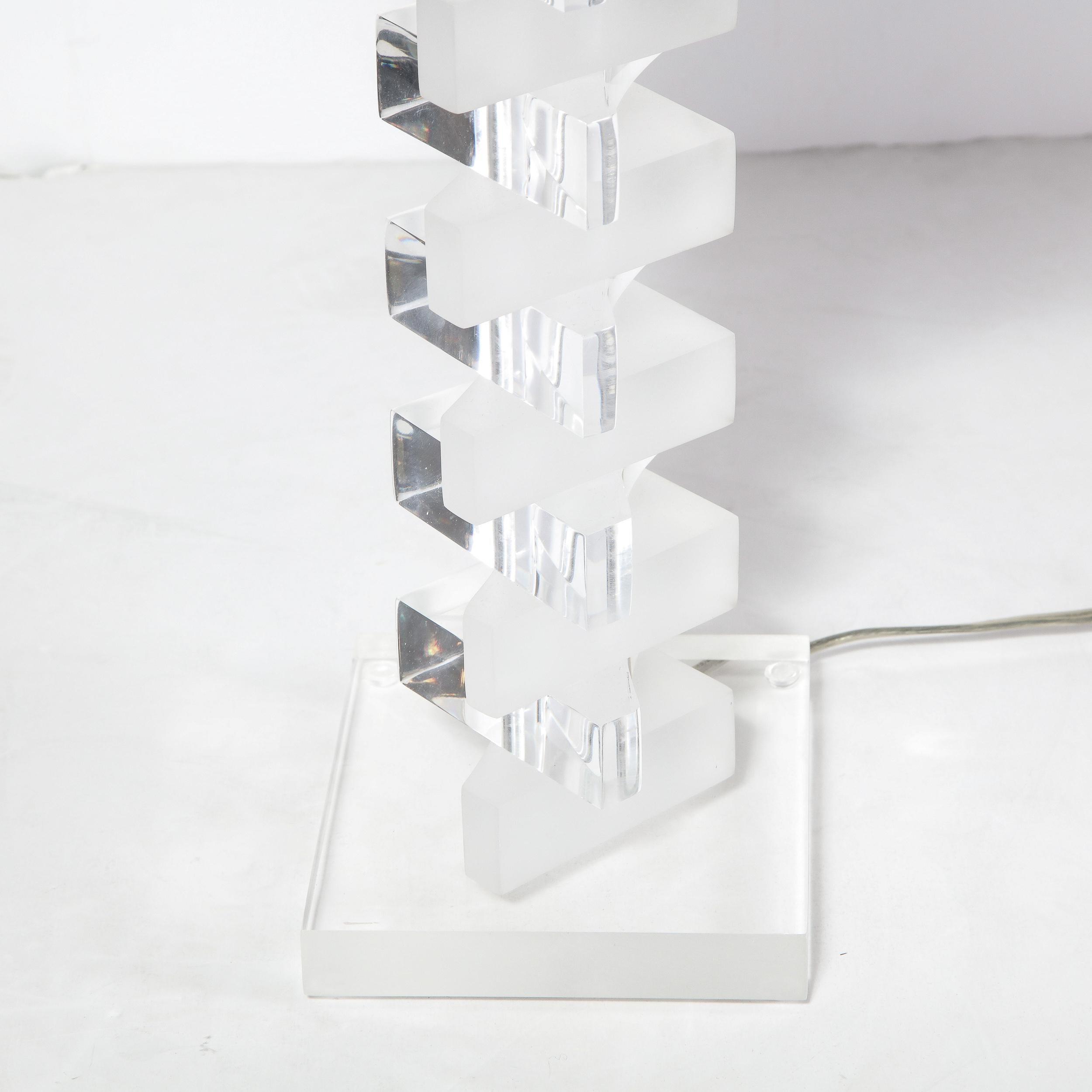 This stunning pair of Mid-Century Modern lamps were realized in the United States circa 1970. They feature
alternating stacked amorphic forms forms in frosted and translucent lucite ascending from a clear square lucite base. With their clean