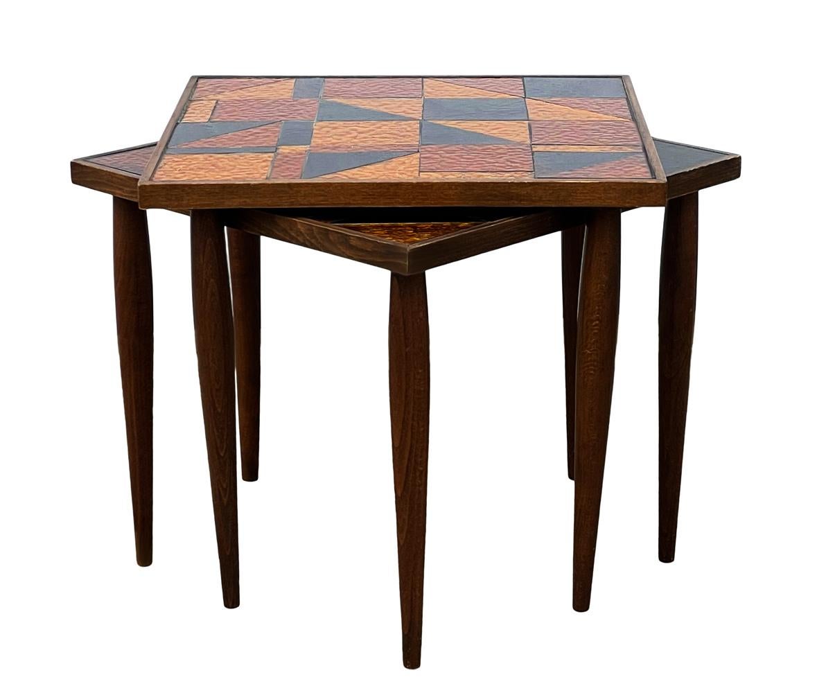 A sharp looking setting of tables by Georges Briard circa 1960's. These feature walnut wood construction with inlayed stained glass. 