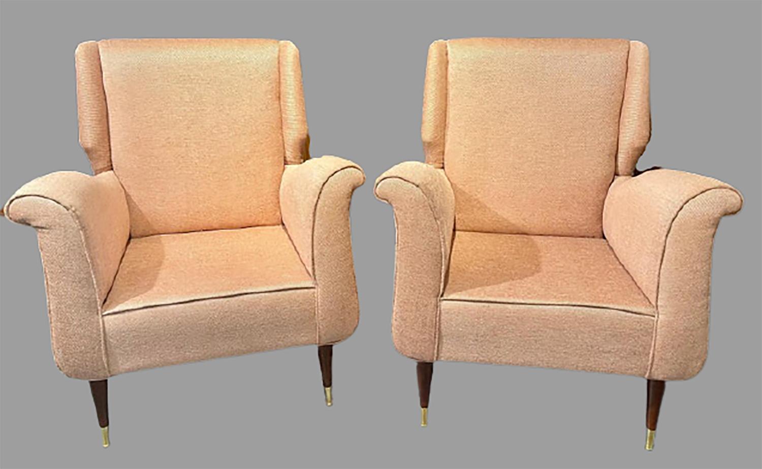 Pair of Mid-Century Modern Gio Ponti style arm or wingback chairs. These finely detailed sleek and stylish armchairs depict this iconic designer’s style for flair and simplicity at his highest level. The tapering mahogany legs sitting on brass