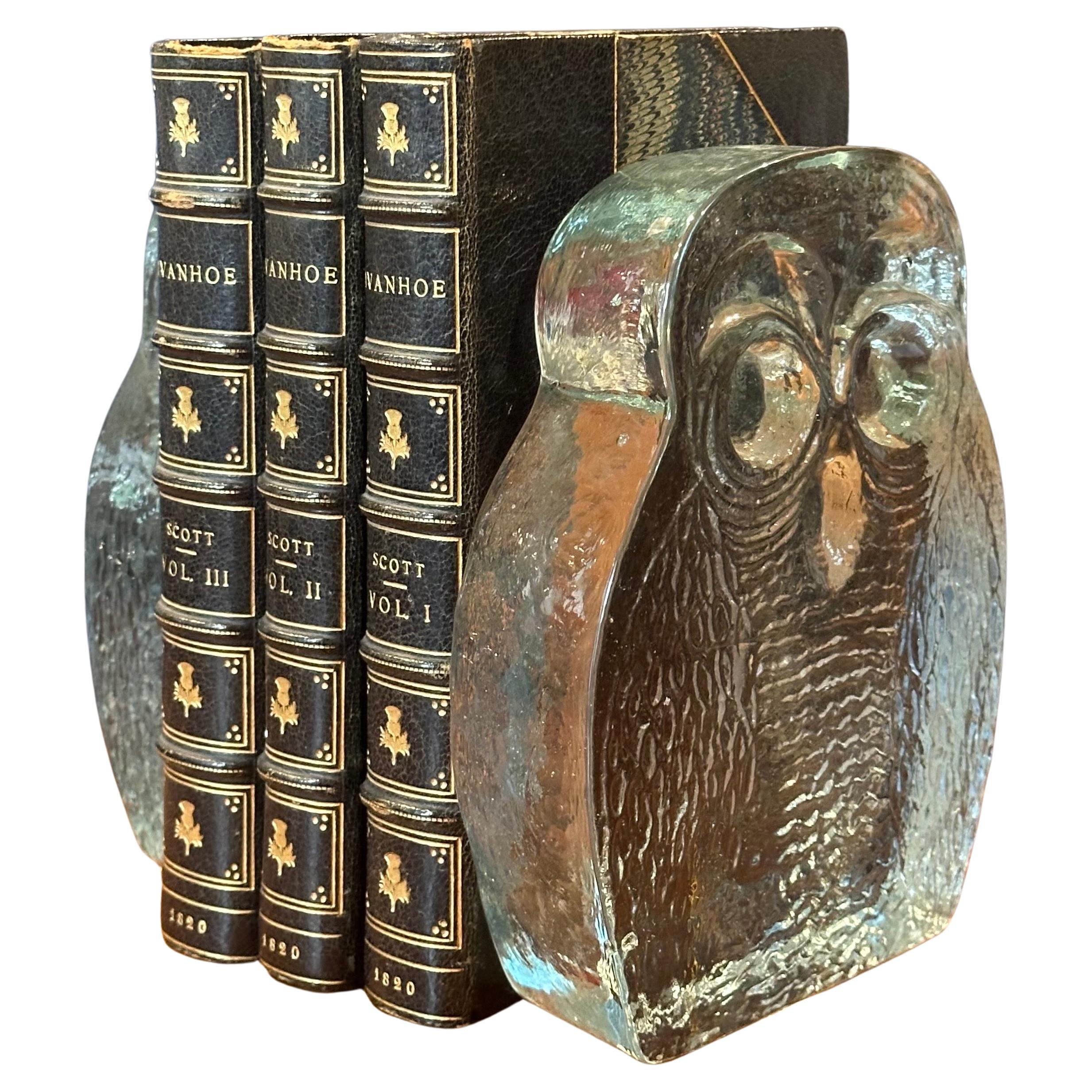 Cool pair of MCM hand-blown glass owl bookends by Blenko, circa 1970s. The bookends are heavy and solid with a smooth back side a finish and a textural finish on the front. Very cool decorative item.  The bookends are clear, see through glass - no