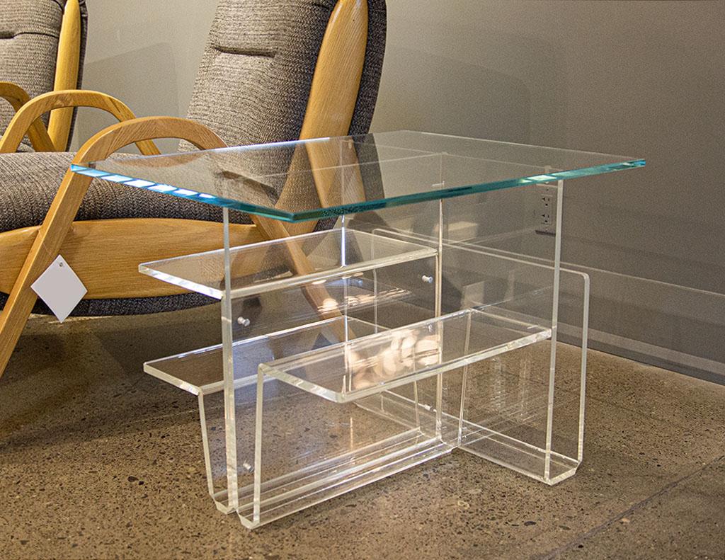 Pair of Mid-Century Modern glass top acrylic end tables magazine stands. Original 1970’s, American, Mid-Century Modern pieces. Unique acrylic design with magazine Stand qualities. Lots of storage options with shelves and different compartments. All