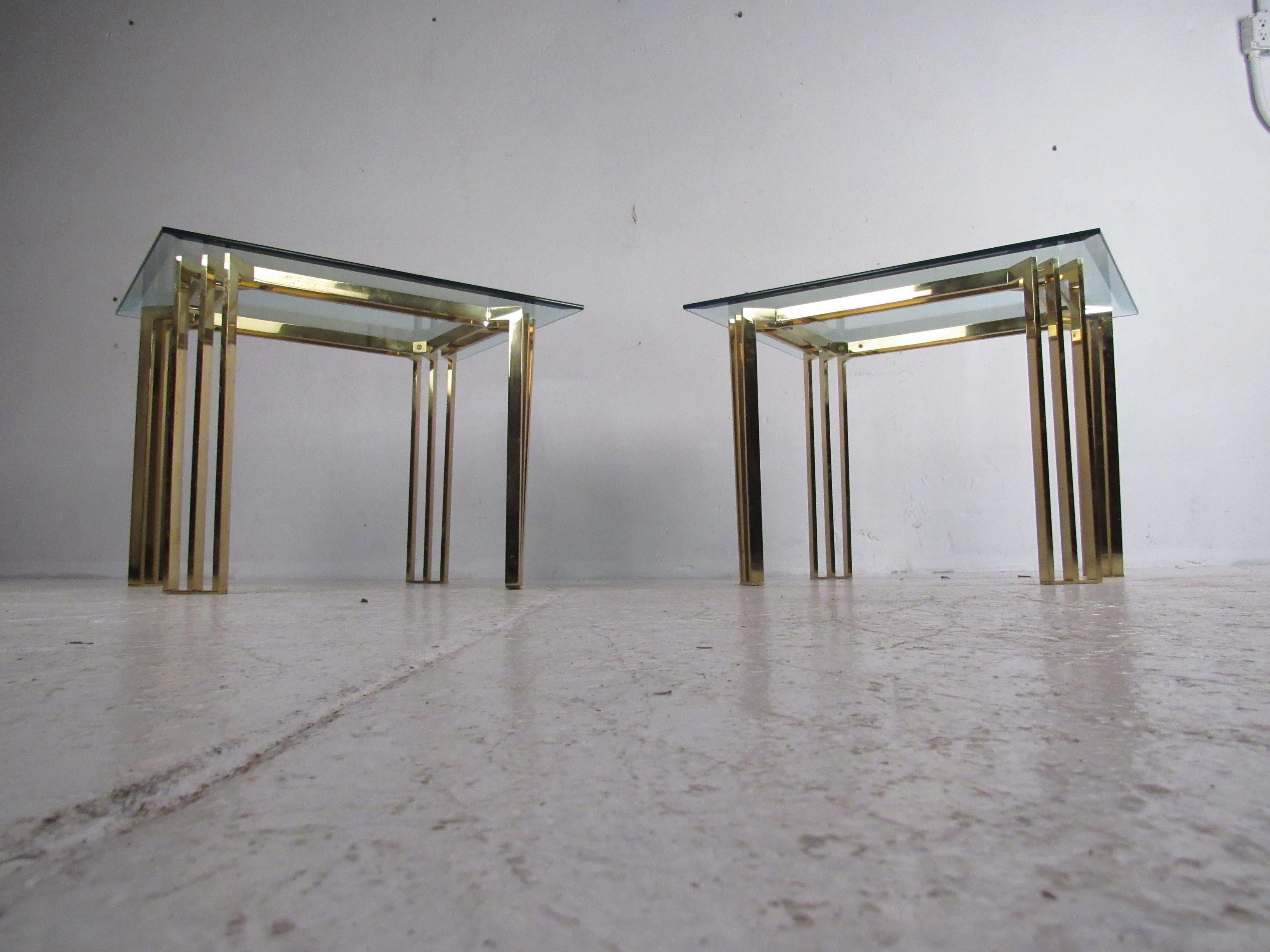 This stunning pair of vintage modern Italian end tables feature rectangular glass tops with beveled edges and flat bar metal bases. A unique design with four sturdy three prong legs and an overhanging glass top. This stylish pair of midcentury side