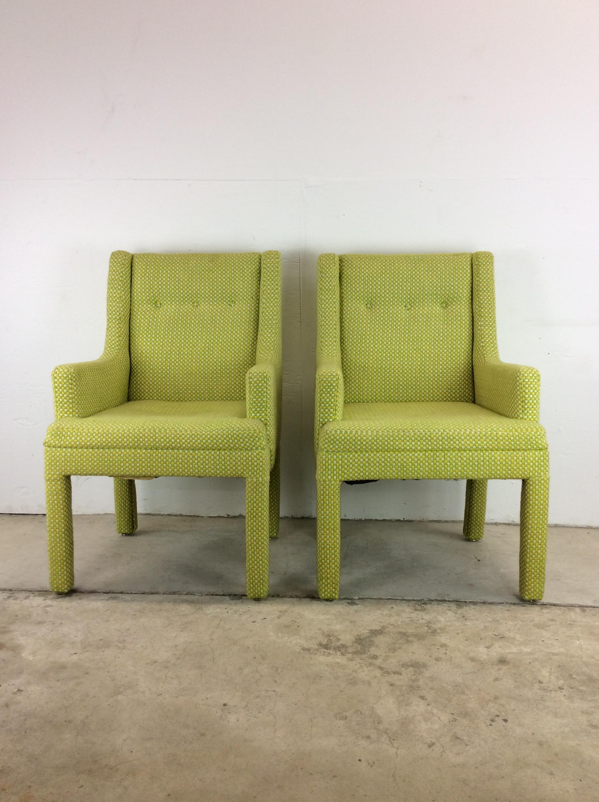 This pair of mid century modern arm chairs features vintage green, white & yellow checked upholstery, three button tufted seat back, wingback design, and tall upholstered legs. 

Check our other listings for similarly funky seating