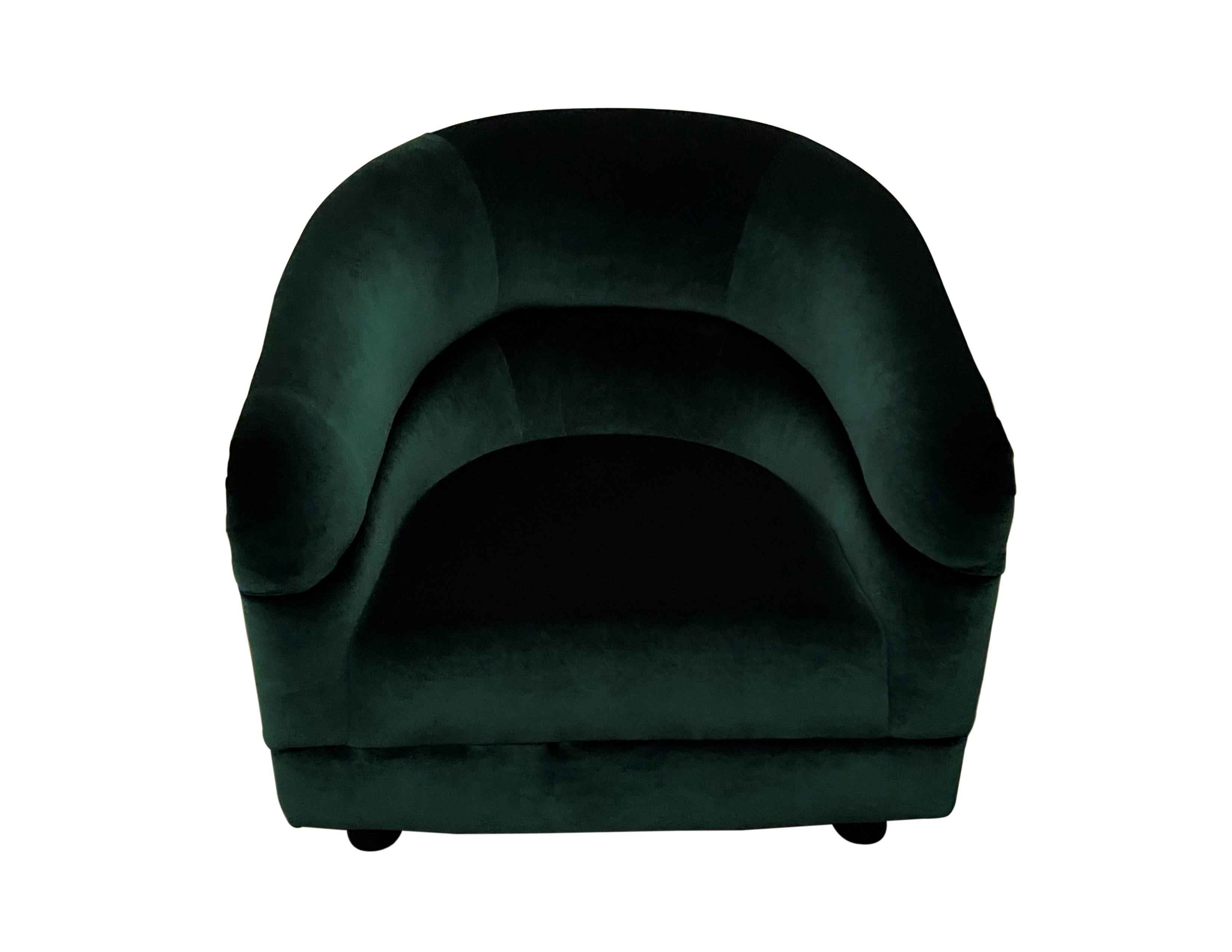 A fabulous pair of Mid-Century Modern barrel back club/lounge chairs, dating from the 1970's. Reupholstered in a luxurious and rich emerald green jewel tone velvet. Very comfortable, stylish and elegant vintage midcentury chairs that work well with