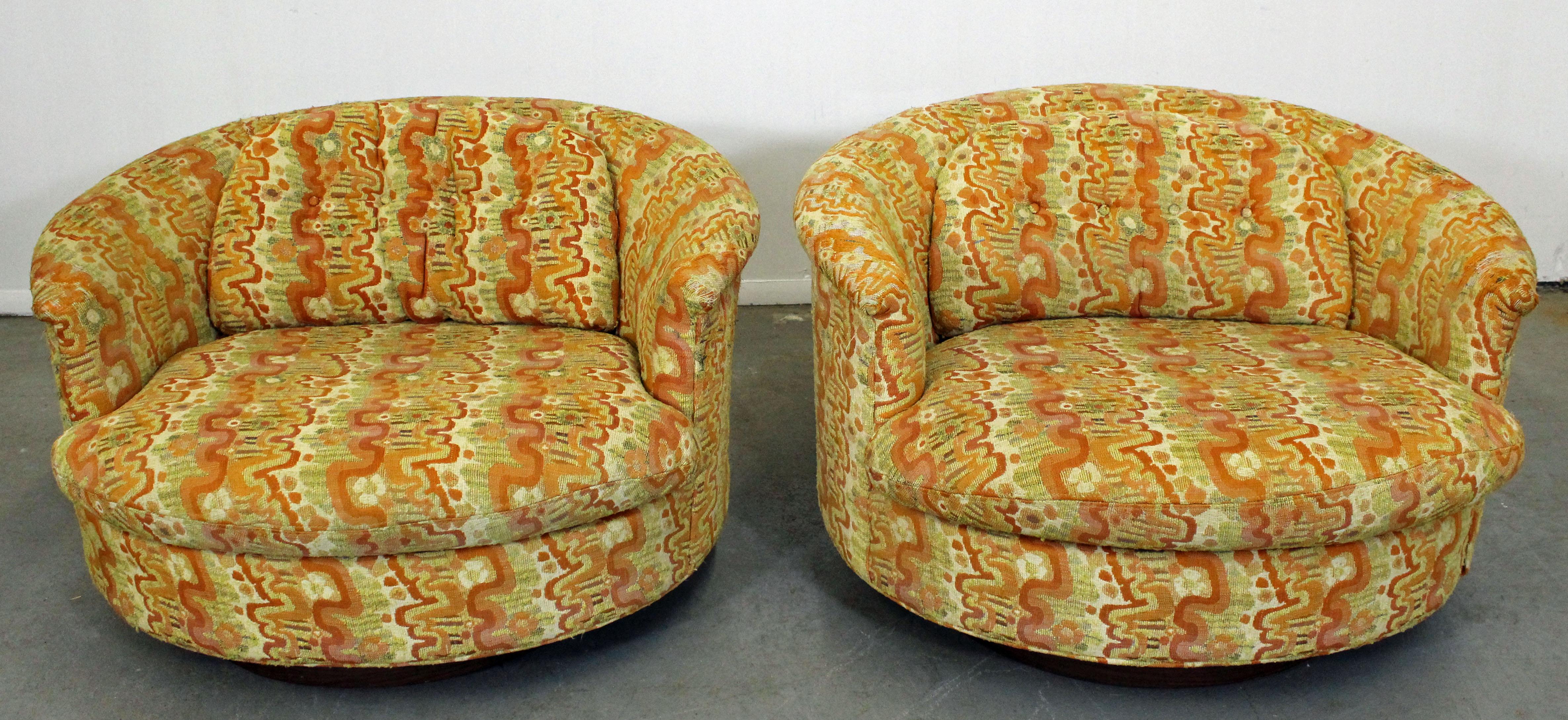What a find. Offered is a pair of groovy, round swivel chairs on wooden bases, by Selig Imperial. They are in decent condition, but need to be reupholstered. They are signed by Selig Imperial.

Dimensions:
40
