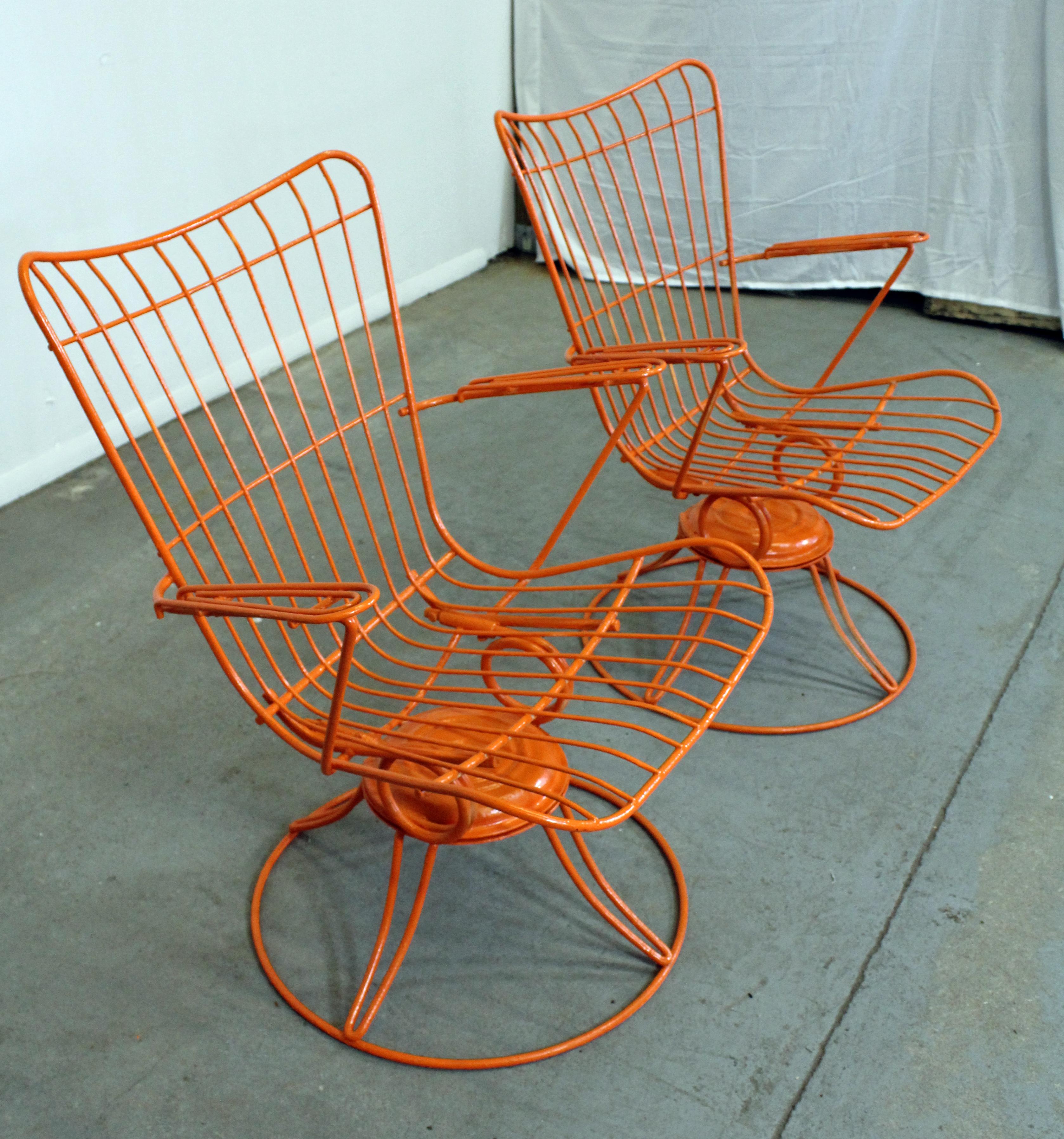 What a find. Offered is a pair of midcentury wrought iron swivel/rocker patio lounge chairs (model 36) made by Homecrest Bottemiller, circa 1968. These chairs swivel and rock, and have been repainted in an atomic orange. They're in good condition