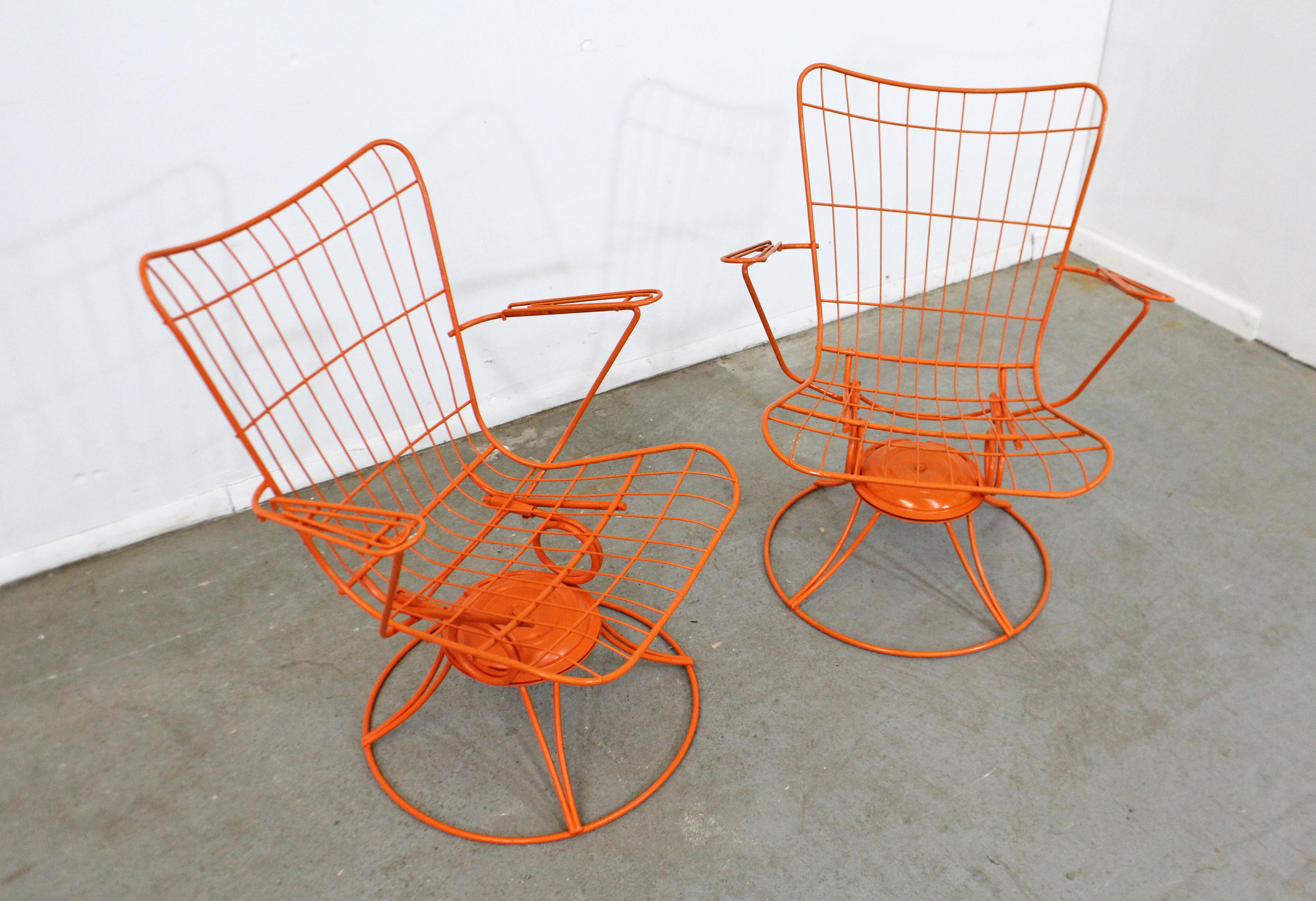 What a find. Offered is a pair of vintage mid-century modern iron swivel/rocker patio lounge chairs (model 36) made by Homecrest Bottemiller, circa 1968. These chairs swivel and rock, and have been repainted in an orange. They're in good condition,