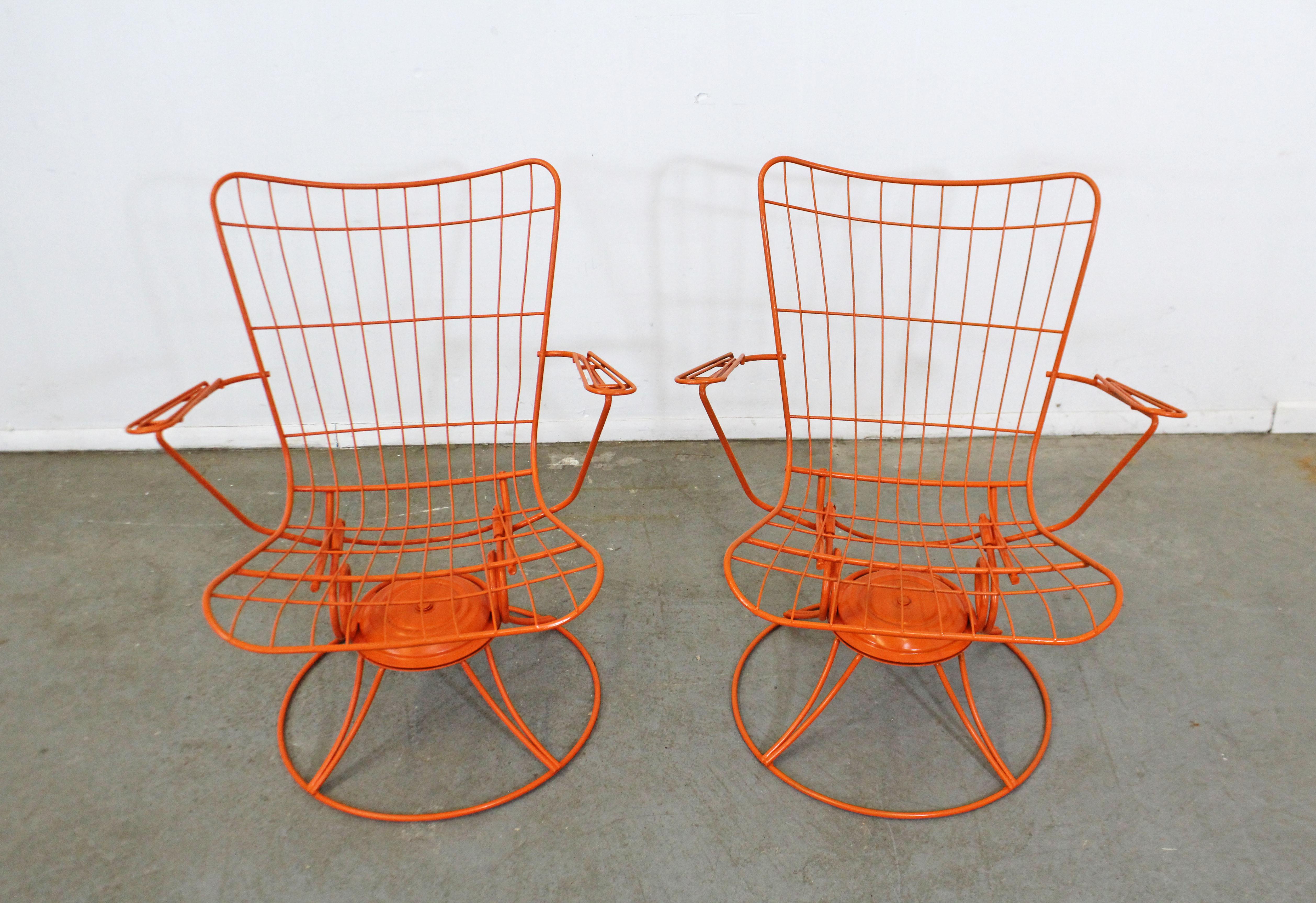What a find. Offered is a pair of vintage Mid-Century Modern iron swivel/rocker patio lounge chairs (model 36) made by Homecrest Bottemiller, circa 1968. These chairs swivel and rock, and have been repainted in an orange. They're in good condition,