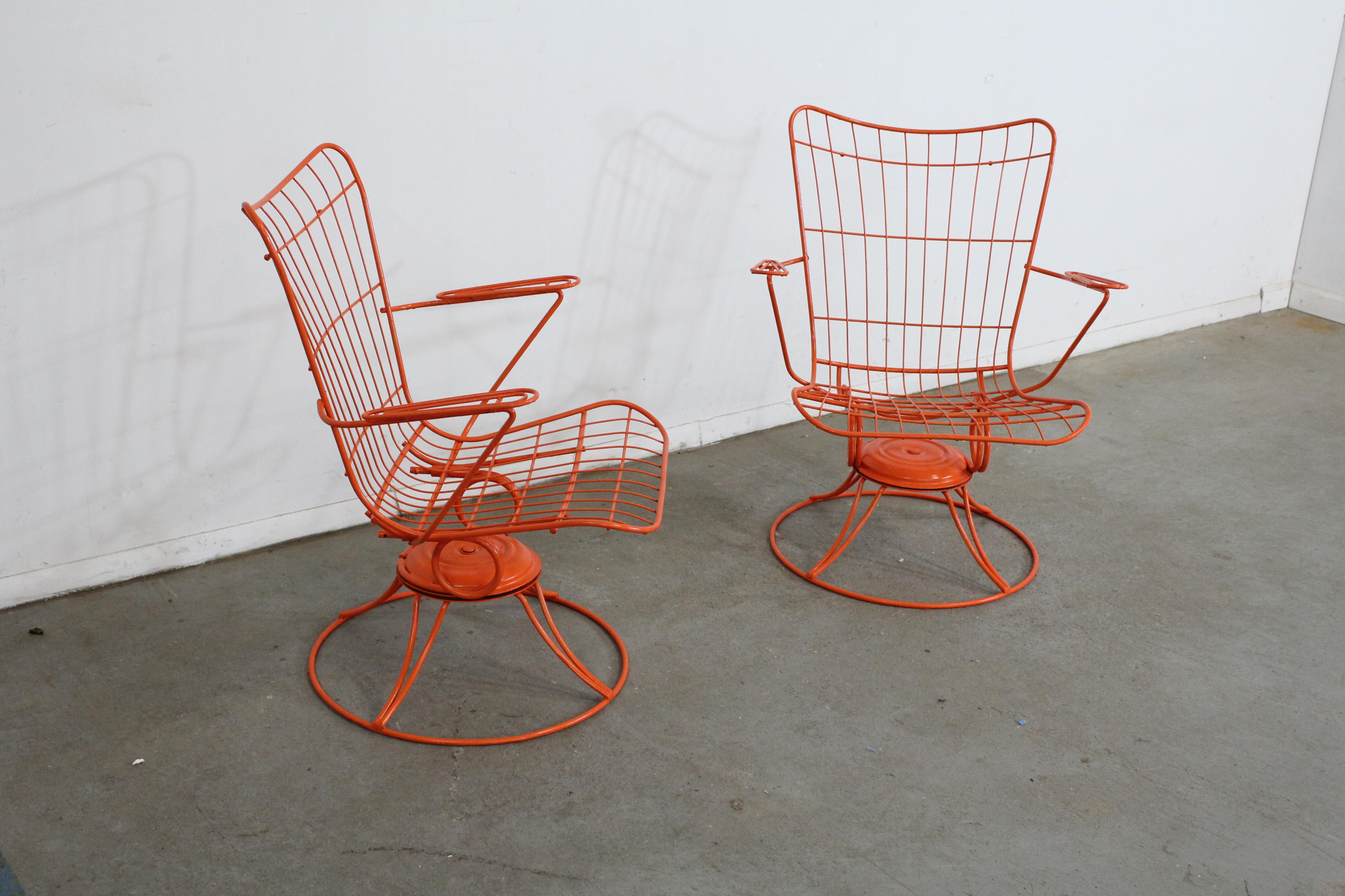 What a find. Offered is a pair of vintage Mid-Century Modern iron swivel/rocker patio lounge chairs (model 36) made by Homecrest Bottemiller, circa 1968. These chairs swivel and rock, and have been repainted in an orange. They're in good condition,