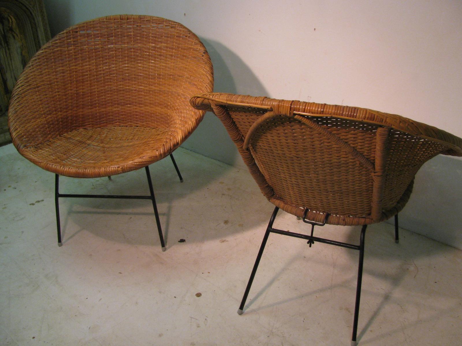 Fabulous pair of midcentury rattan hoop chairs. Iron base with woven rattan seat and sides. Condition is great with no breaks and are very sturdy. Slight bend in one front leg, #3 and #4 chairs.