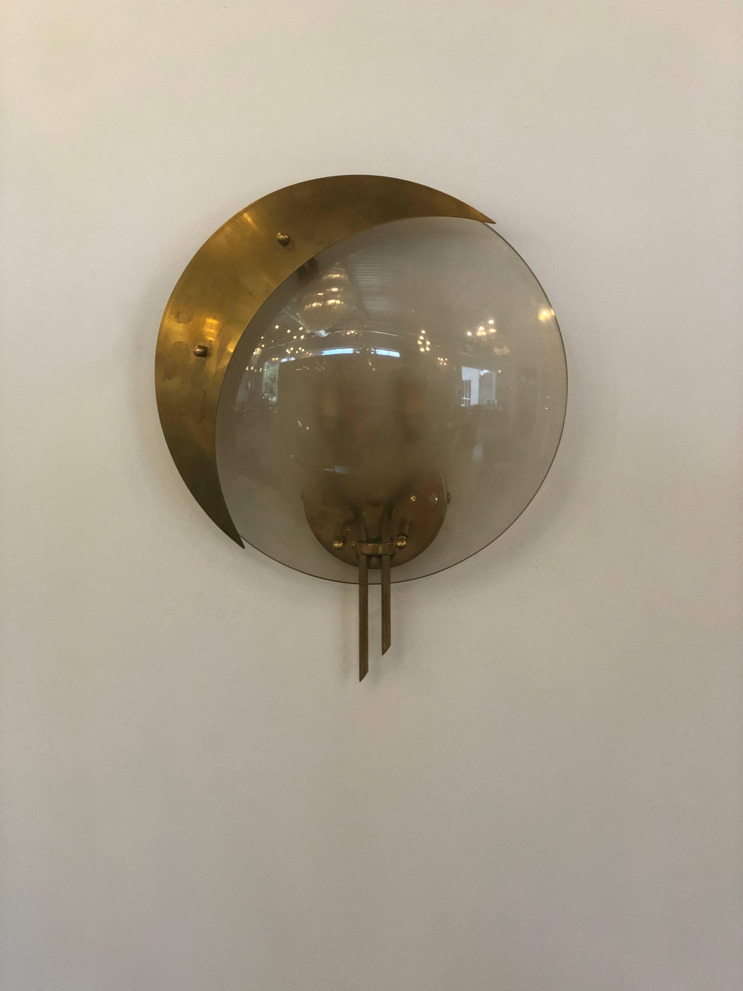 Offered is a pair of Mid-Century Modern Italian Gio Ponti attributed Murano glass and brass sconces. Each have two candelabra bases. This iconic pair of Ponti sconces is in of themselves pieces of art sculpture for the wall.  The pair were re-wired