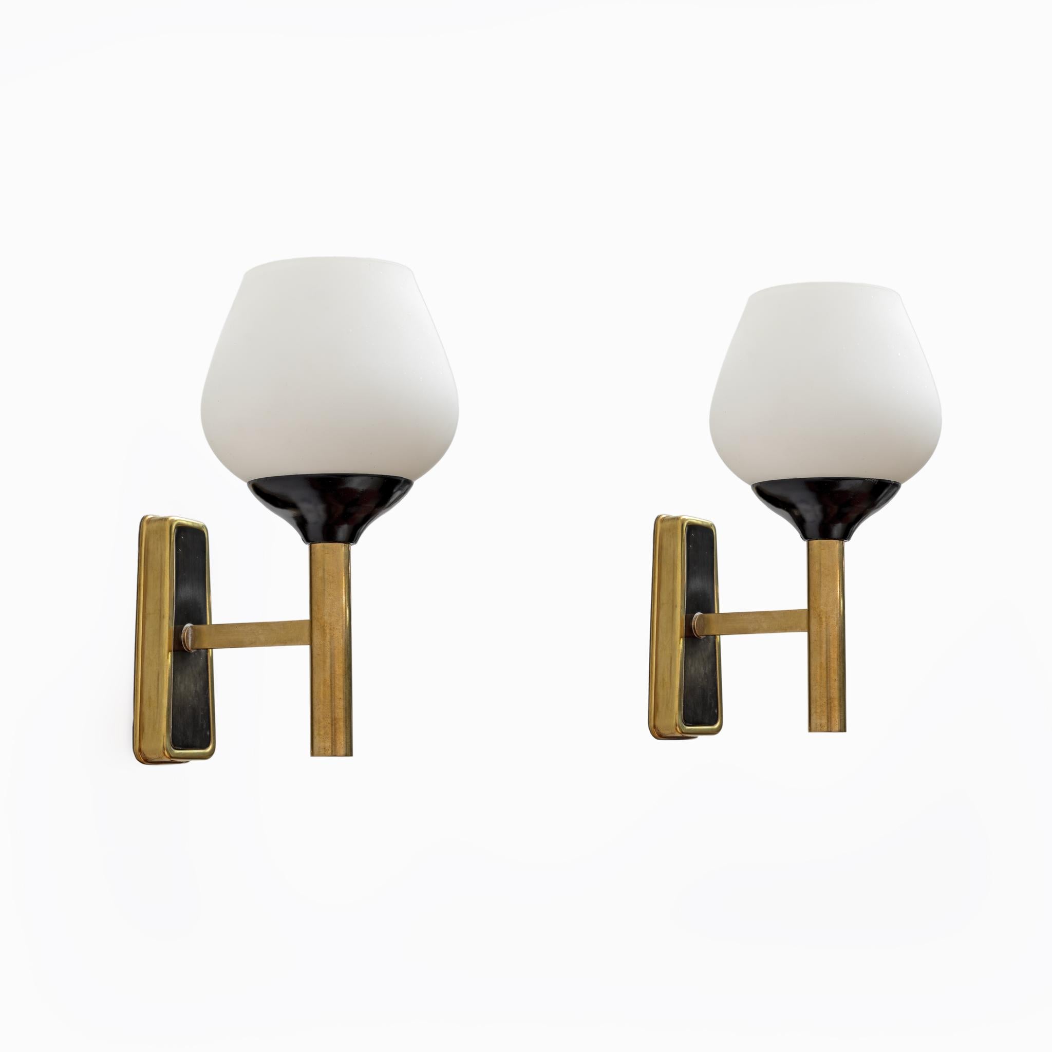 Pair of wall lights produced in Italy in the 1950s, in Stilnovo style, in opaline glass and brass. They have been restored and rewired, they have E14 or E12 lamp holders for the USA.