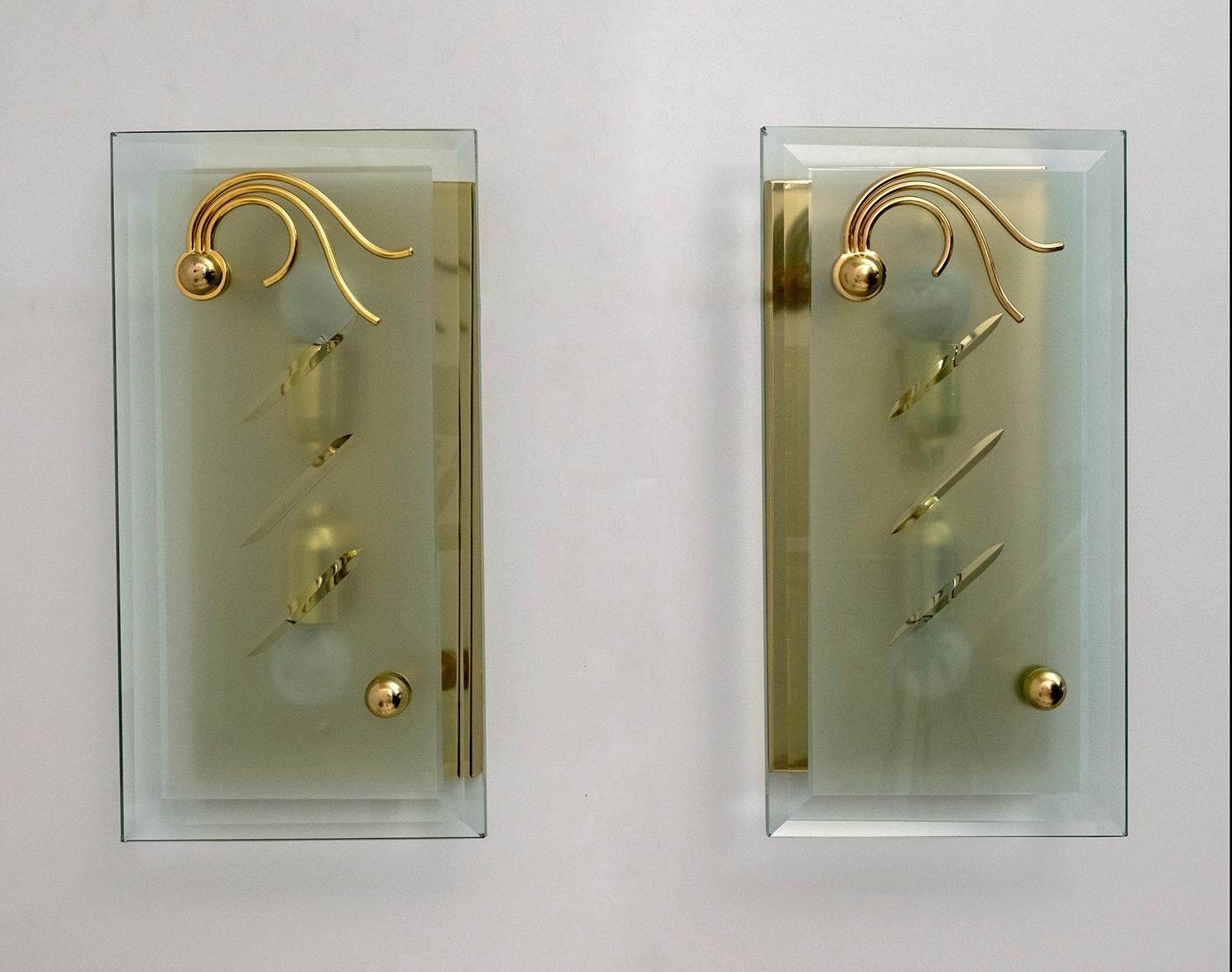 Pair of thick cut crystal sconces, the structure is brass. Italian production of the 70s

