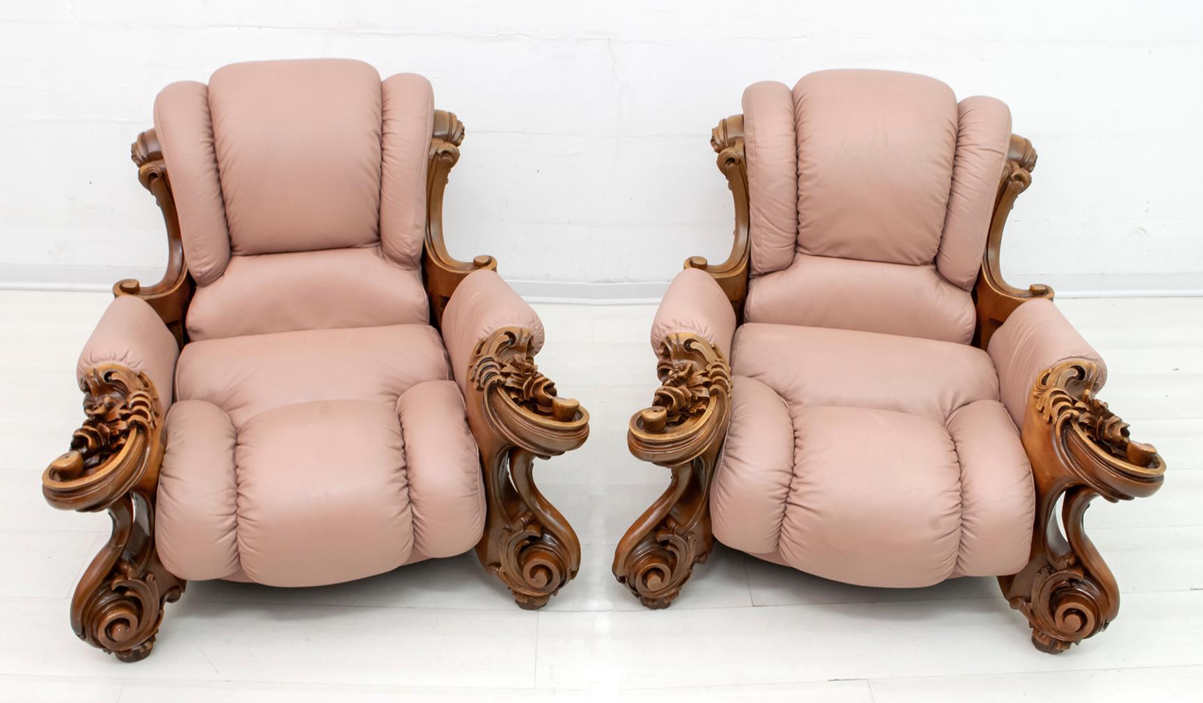 Pair of armchairs made in the 1950s, in genuine leather and carved poplar wood, with liberty motifs.