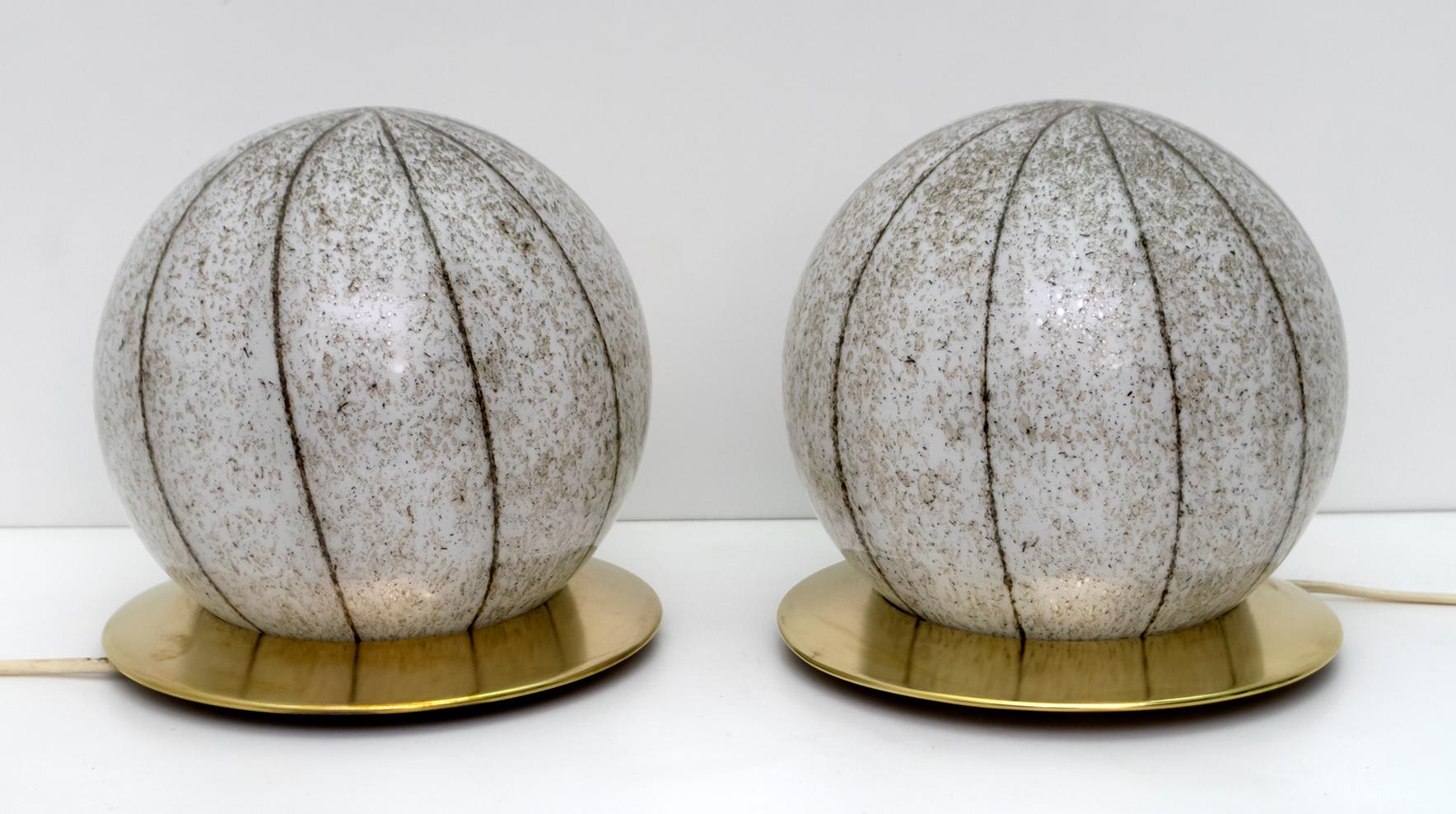 Pair of Murano blown glass sphere lamps and brass bases. Production of the 1960s.