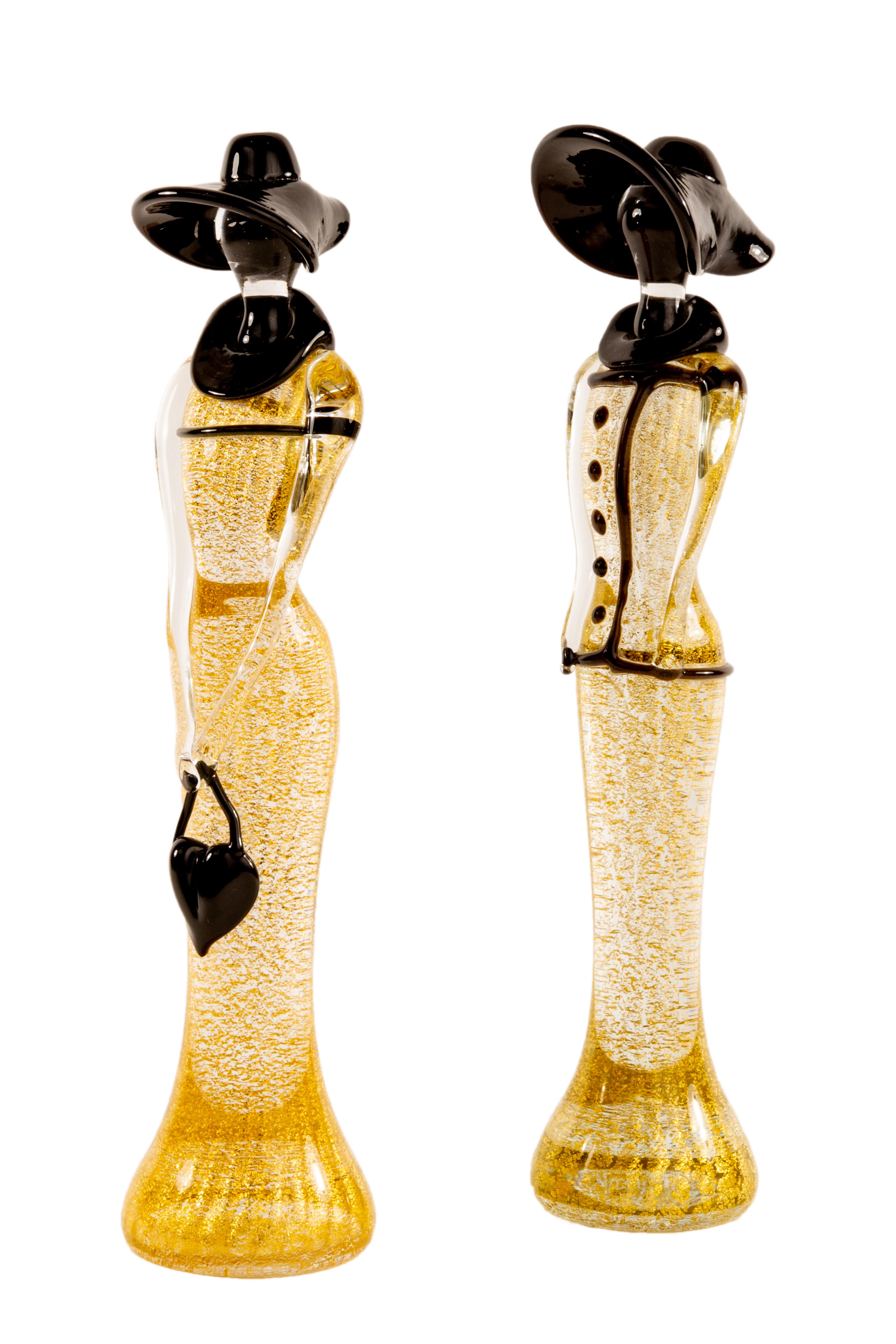 A pair of Mid-Century Modern Italian blown glass sculpture figurines by, Mario Badioli for Ogetti. Each figurine in 1920s' style depicts two females; one figure wearing a large black hat and buttoned blouse and the other figure with a purse. The