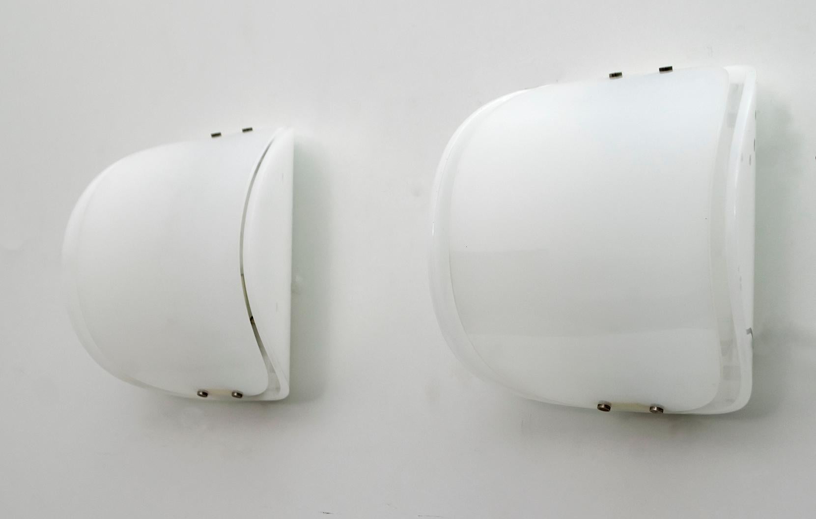 Set of two wall lamps with plexiglass body and metal details.