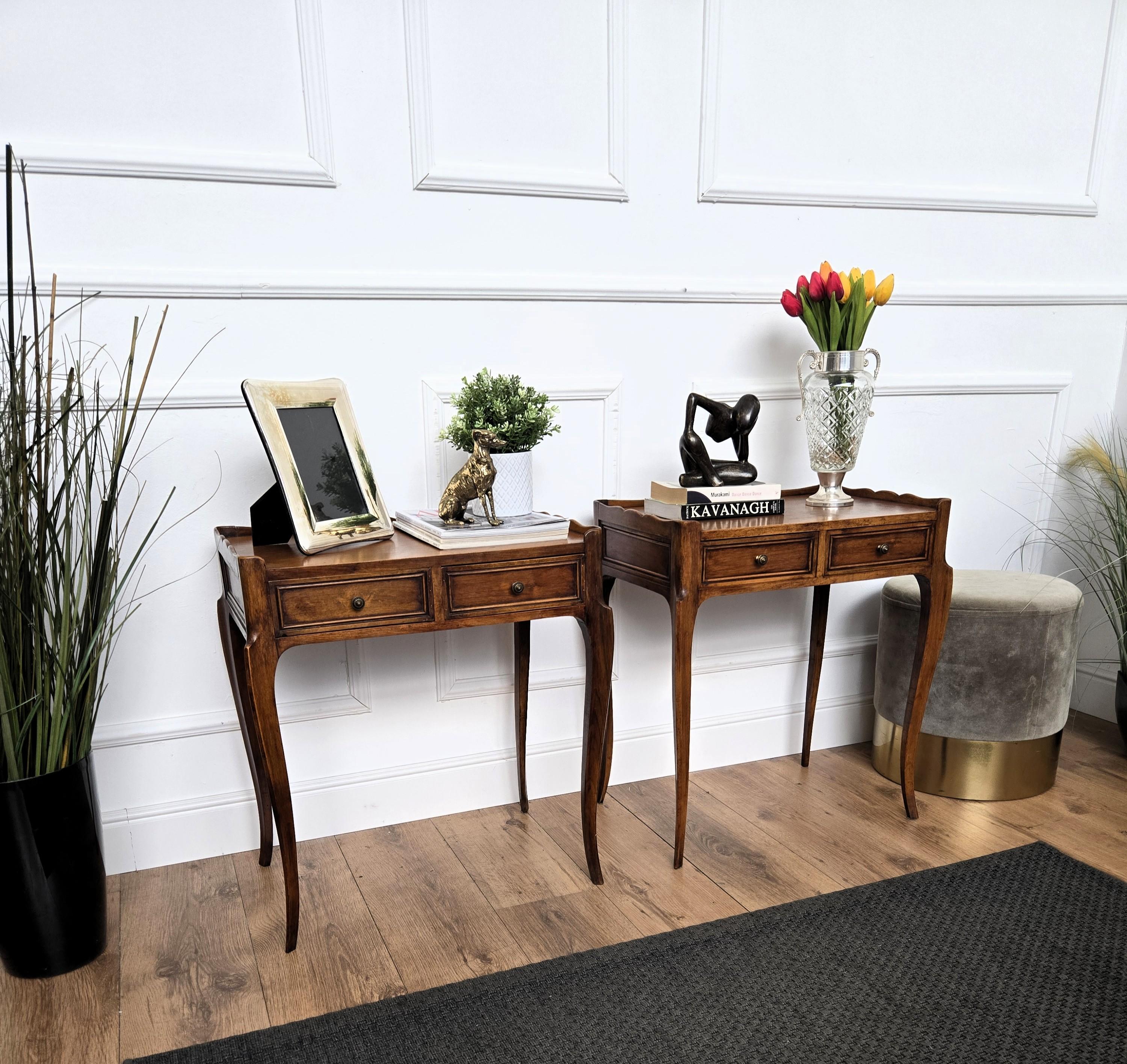 Very elegant and refined Italian 1950s Mid-Century Modern pair of side tables as well as bedside tables with double drawer and brass handles. Great attention to detail in the framed surfaces and fronts, carved legs and overall shape and design.