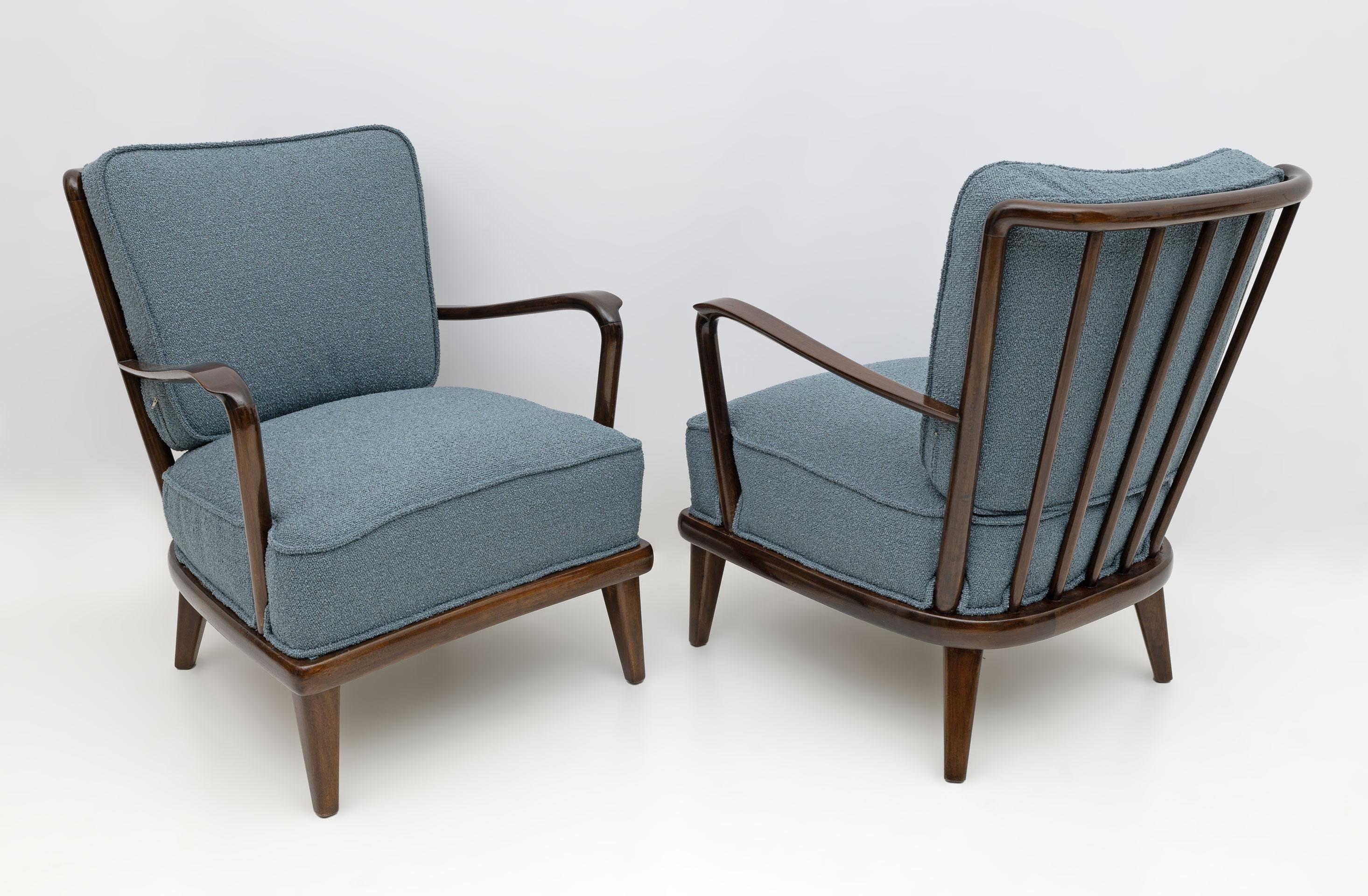 Made in Italy from the 1950s, this pair of spectacular lounge chairs! With its dark walnut frame, understated curved back top and swooping armrests, these lounge chairs represent the best of elegant modern Italian design. Upholstered in fine bouclé,