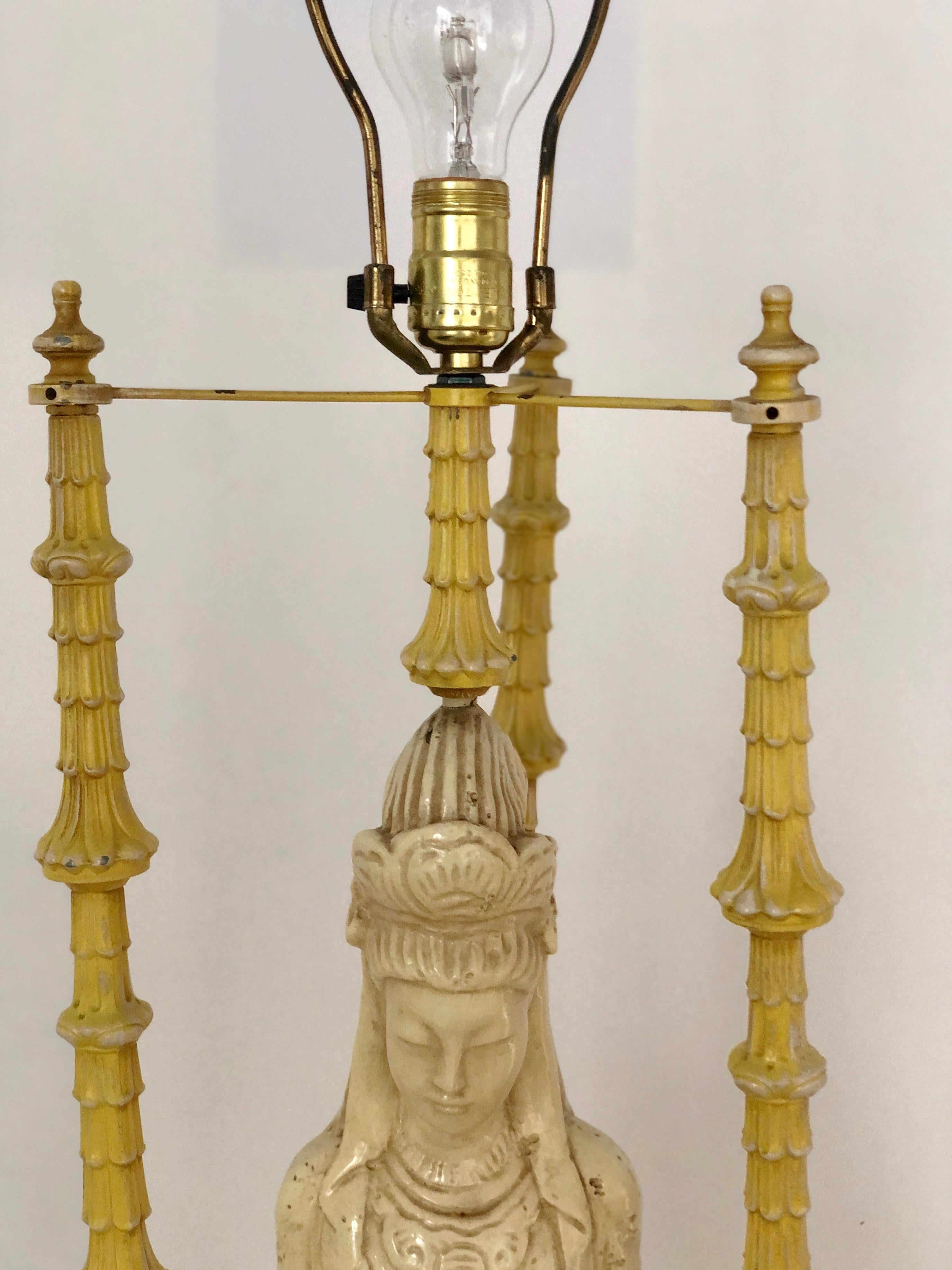 Offered is a Mid-Century Modern Hollywood Regency pair of James Mont Quan Yin chinoiserie style table lamps in a creamy antiqued ivory and pale butter cream yellow. This statuesque 