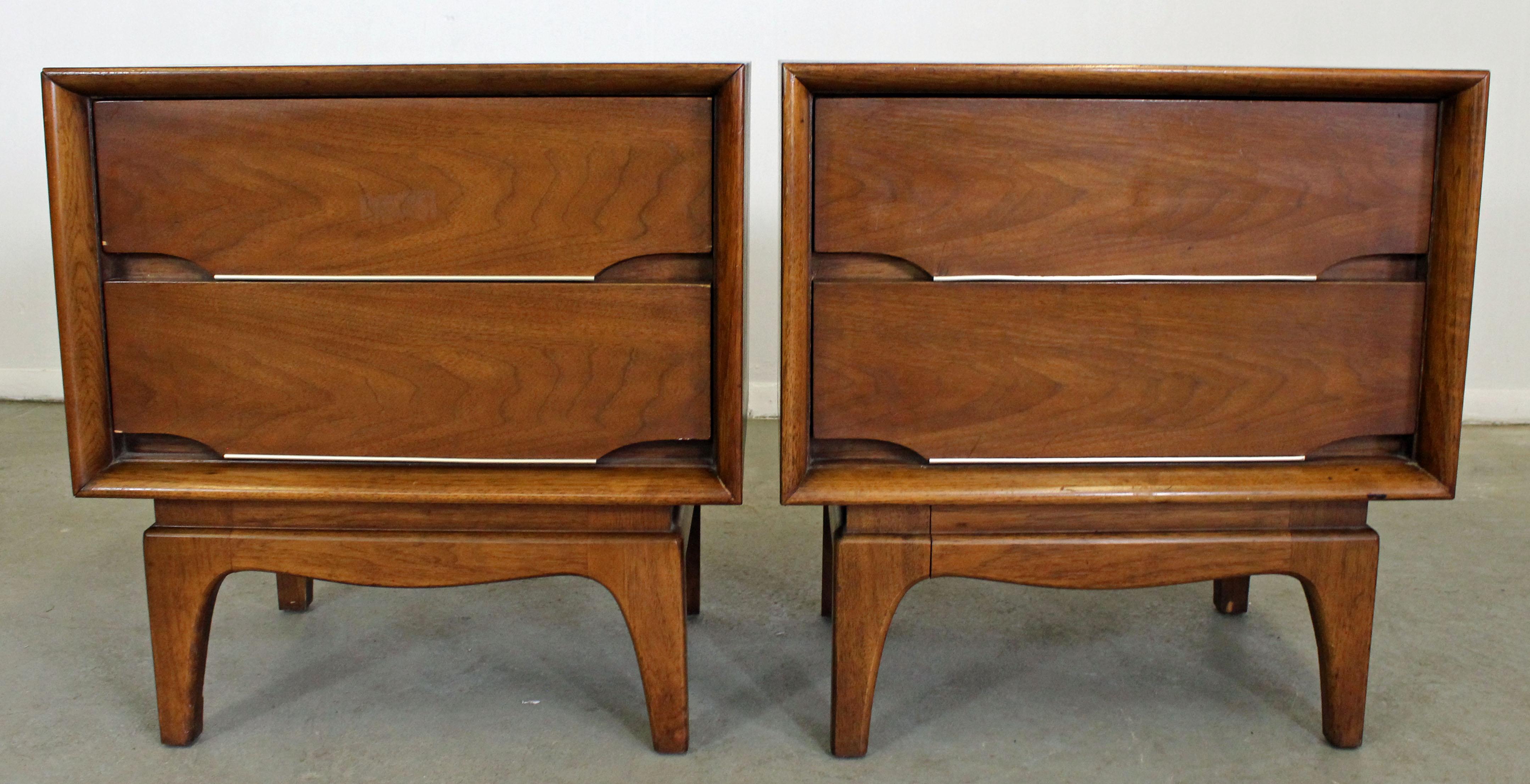 Offered is a pair of walnut nightstands made by Kent Coffey 