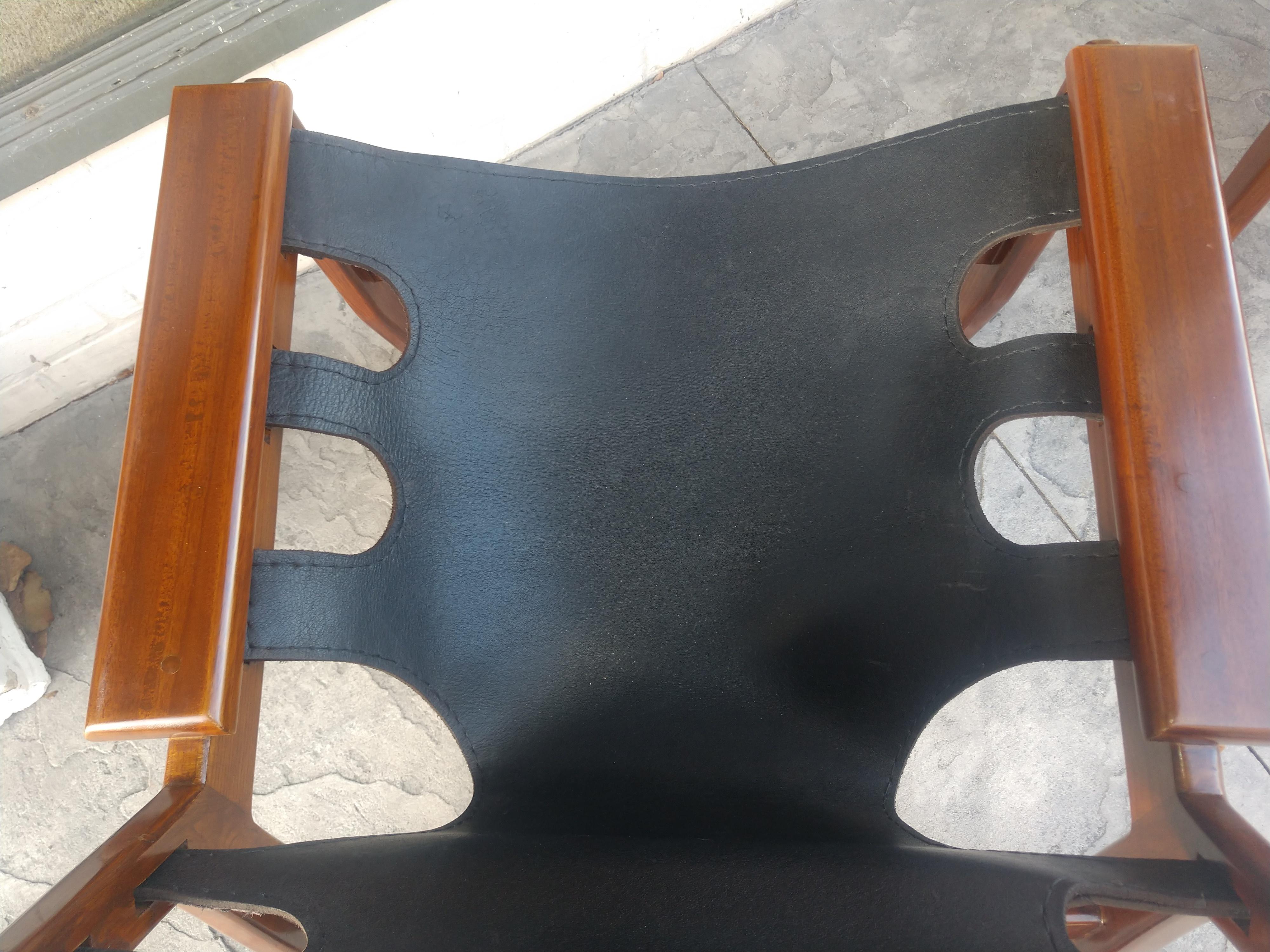 Simple and elegant pair of Mid-Century Modern sculptural leather lounge chairs with Mahogany frames by Sergio Rodrigues. In excellent vintage condition with minimal wear. Sold as a pair.