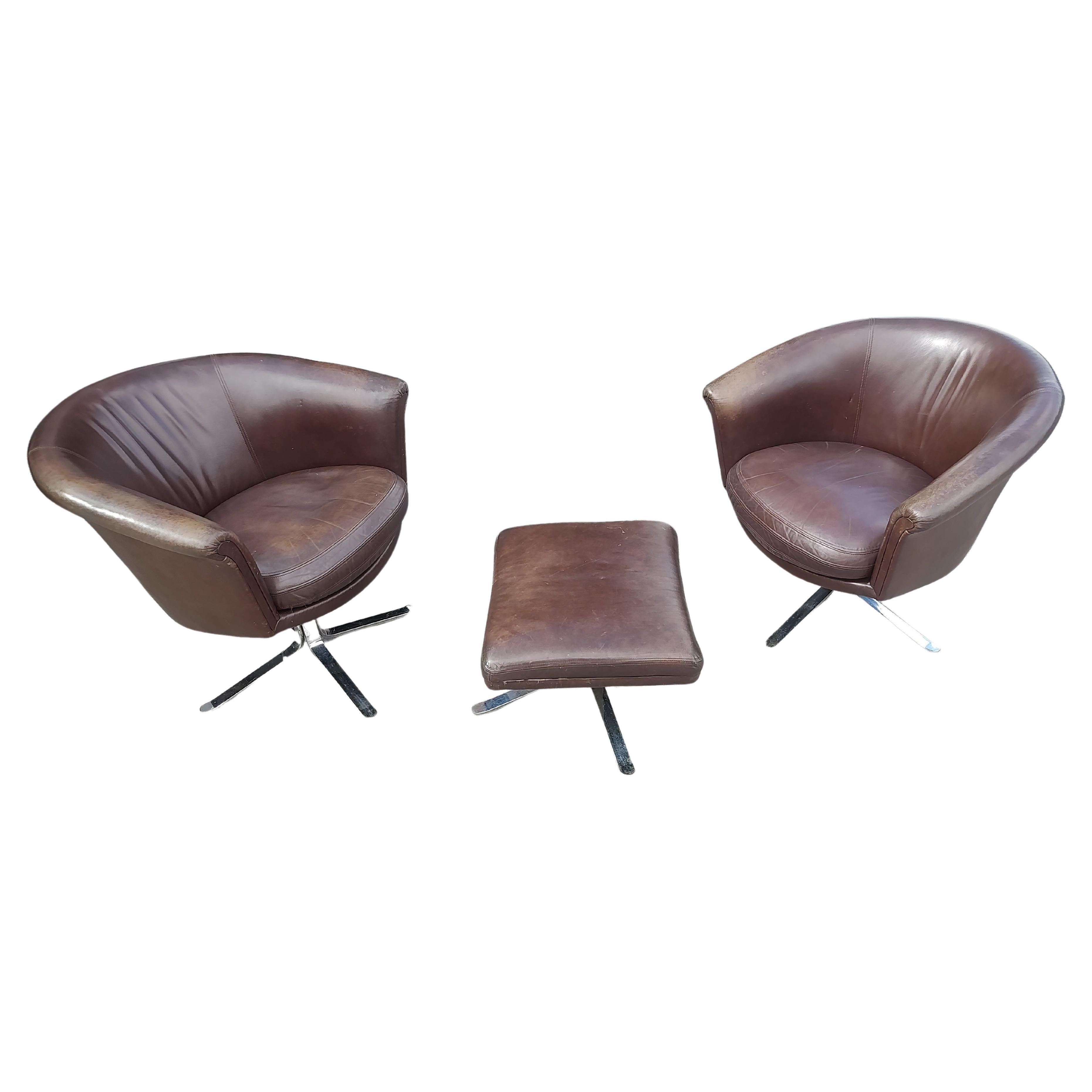 Fantastic pair of Mid Century Modern Sculptural Swiveling Lounge chairs in leather with an ottoman. Heavy duty frame with great style and support. Very comfortable, one chair is a bit higher than the other, 1.5 inches. Nicos Zographos chairs with
